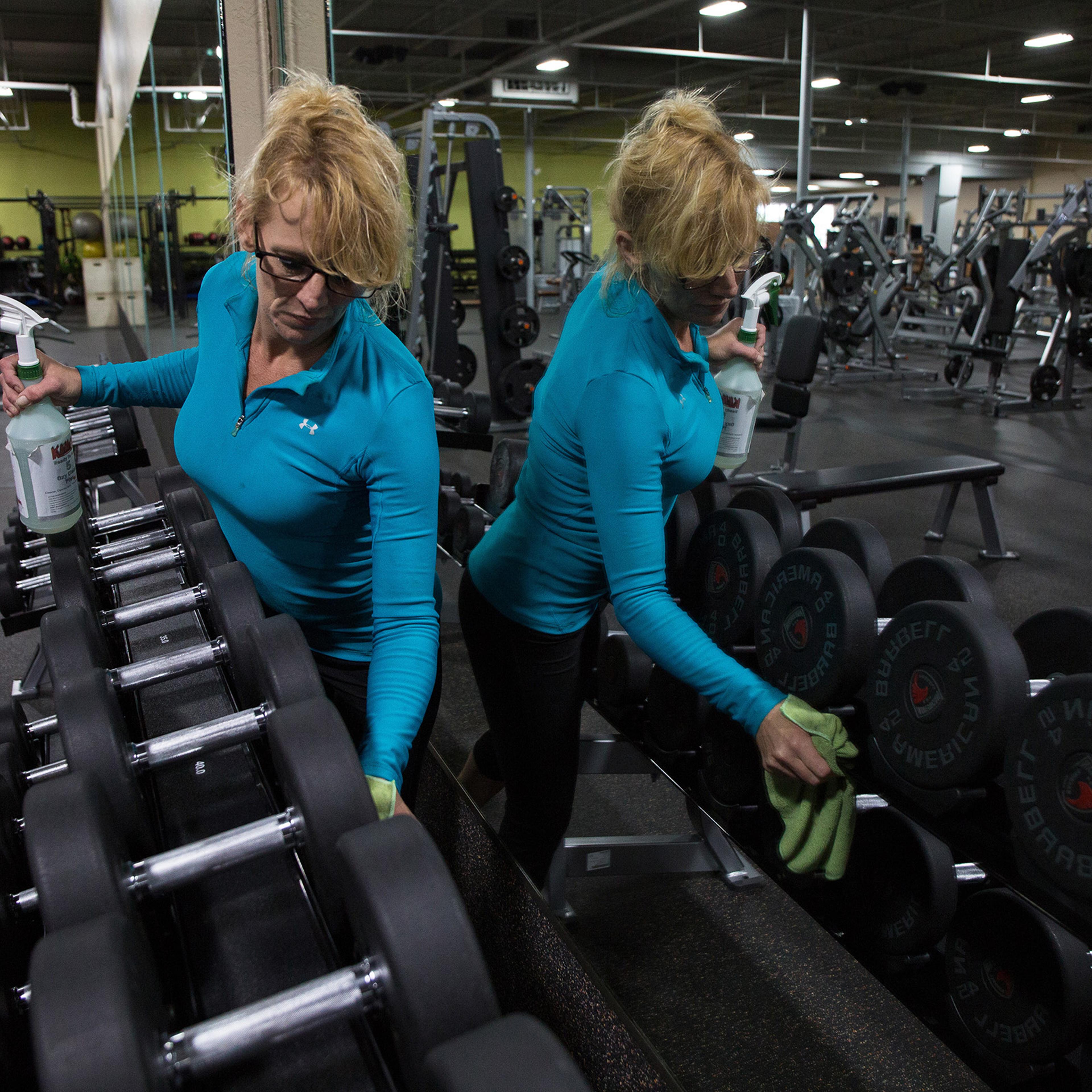 A Gold's Gym worker cleans before reopening, Evans, Ga., April 23, 2020. (OK McCausland/The New York Times)