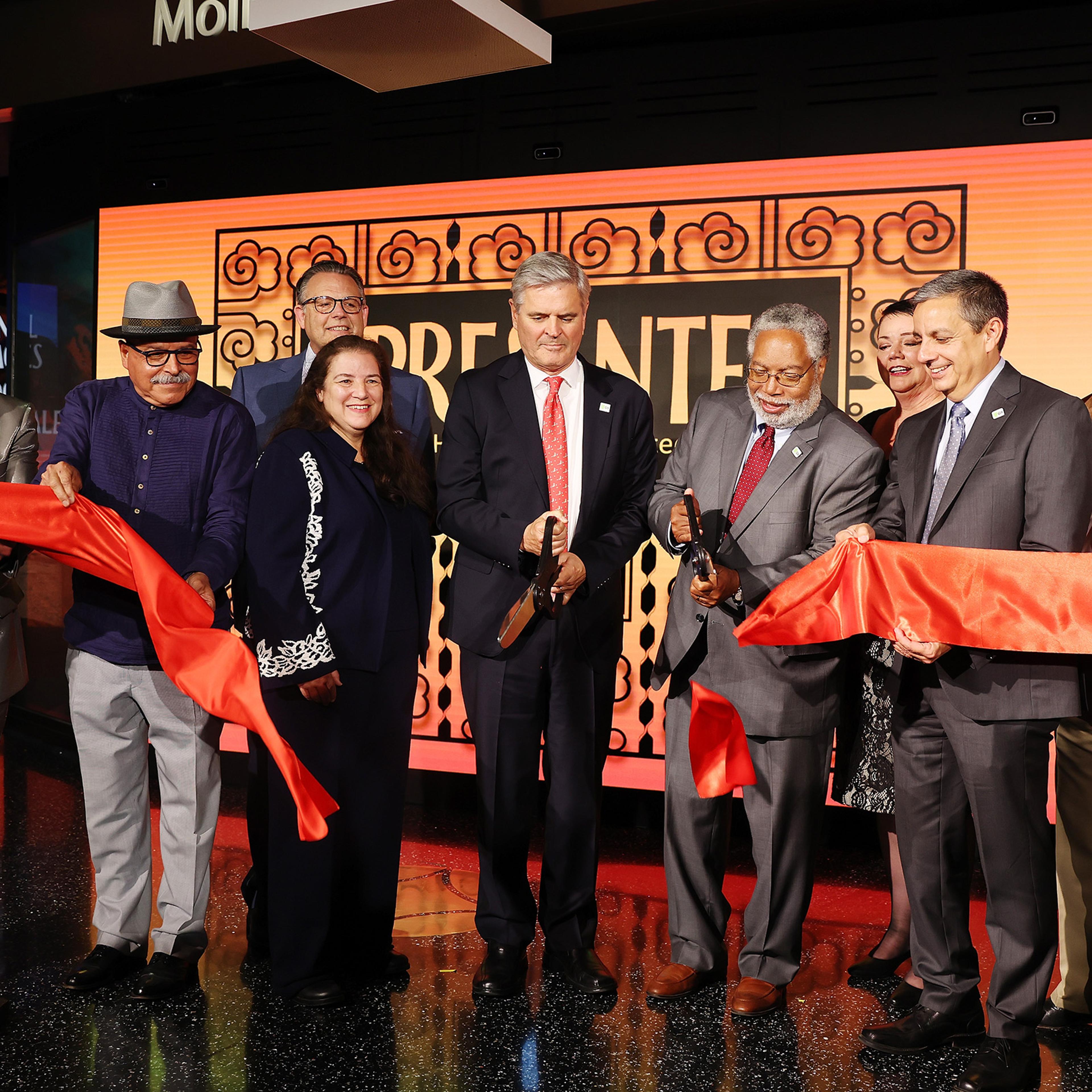 From left: Henry R. Muñoz III, Eduardo Díaz, J. Mario Molina, Martha Molina Bernadett, Steve Case, Lonnie Bunch, III, Josephine Molina, Jorge Zamanillo and John C. Molina cut the opening ribbon during the '¡Presente! A Latino History of the United States