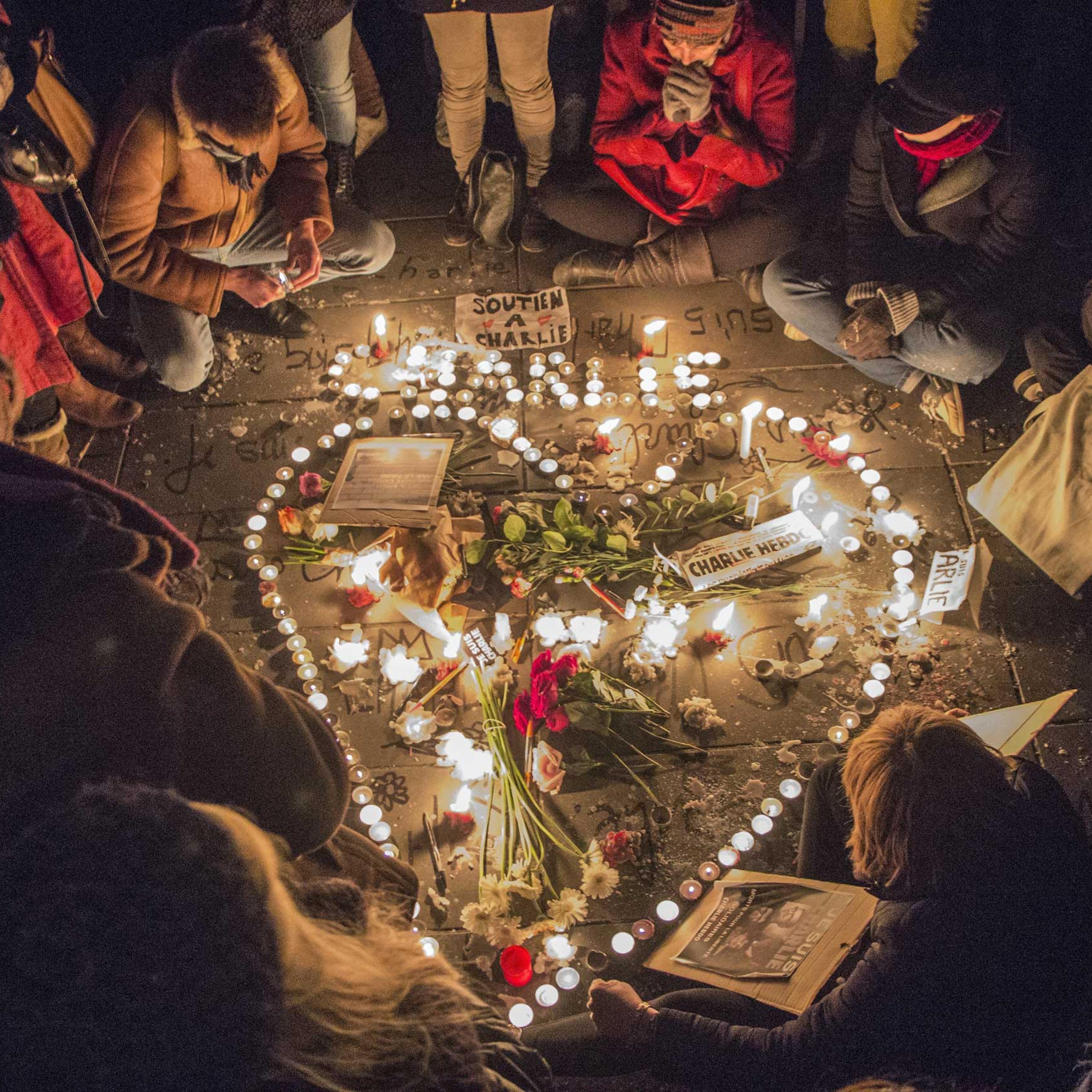 A tribute of flowers and candles in the shape of a heart is set up at Place de la Republique in Paris in memory of the victims of the Charlie Hebdo terrorist attack, on Jan. 7, 2015 in Paris.