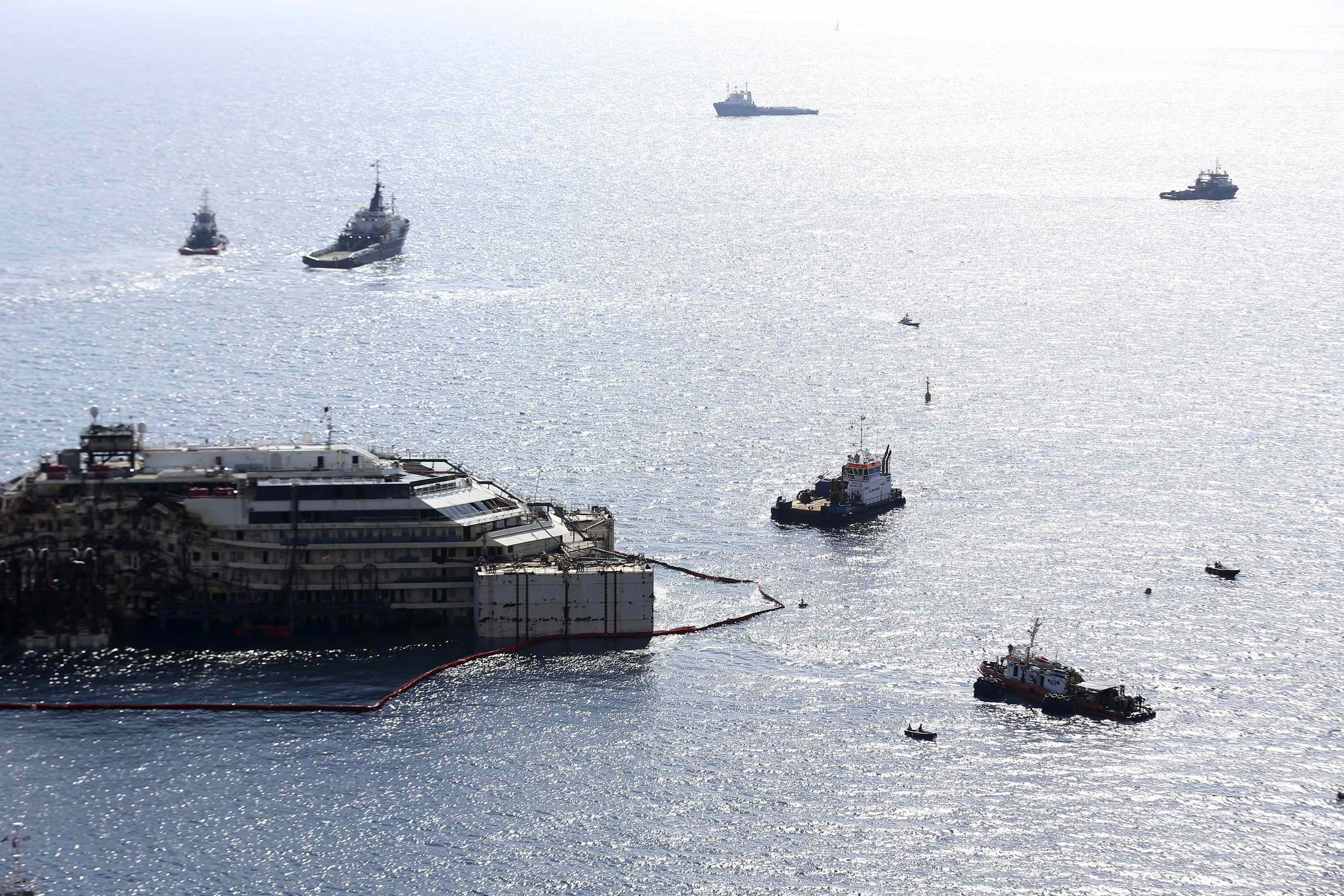 Cruise liner Costa Concordia is surrounded by tugboats during a refloat operation at Giglio harbour at Giglio Island July 14, 2014.