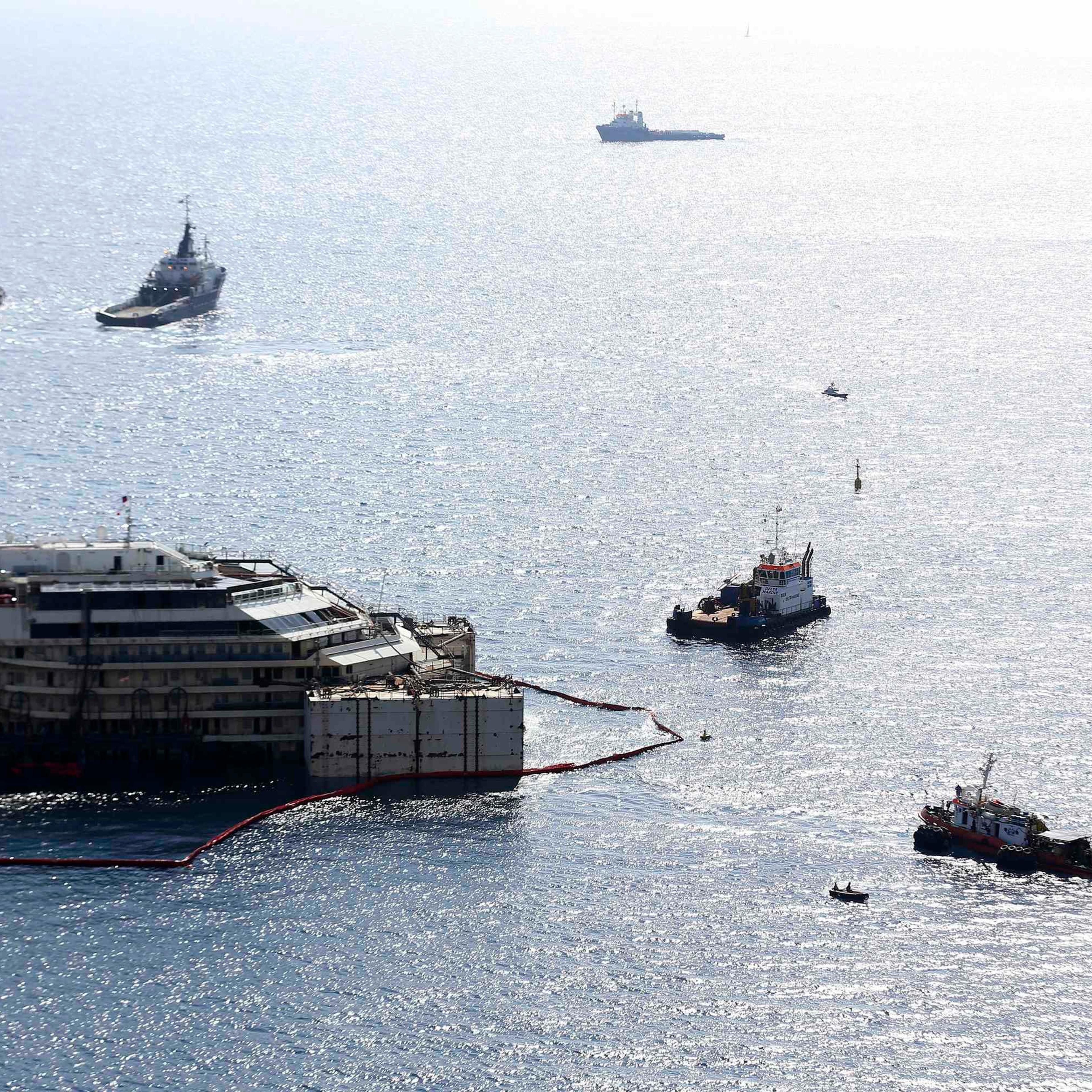 Cruise liner Costa Concordia is surrounded by tugboats during a refloat operation at Giglio harbour at Giglio Island July 14, 2014.