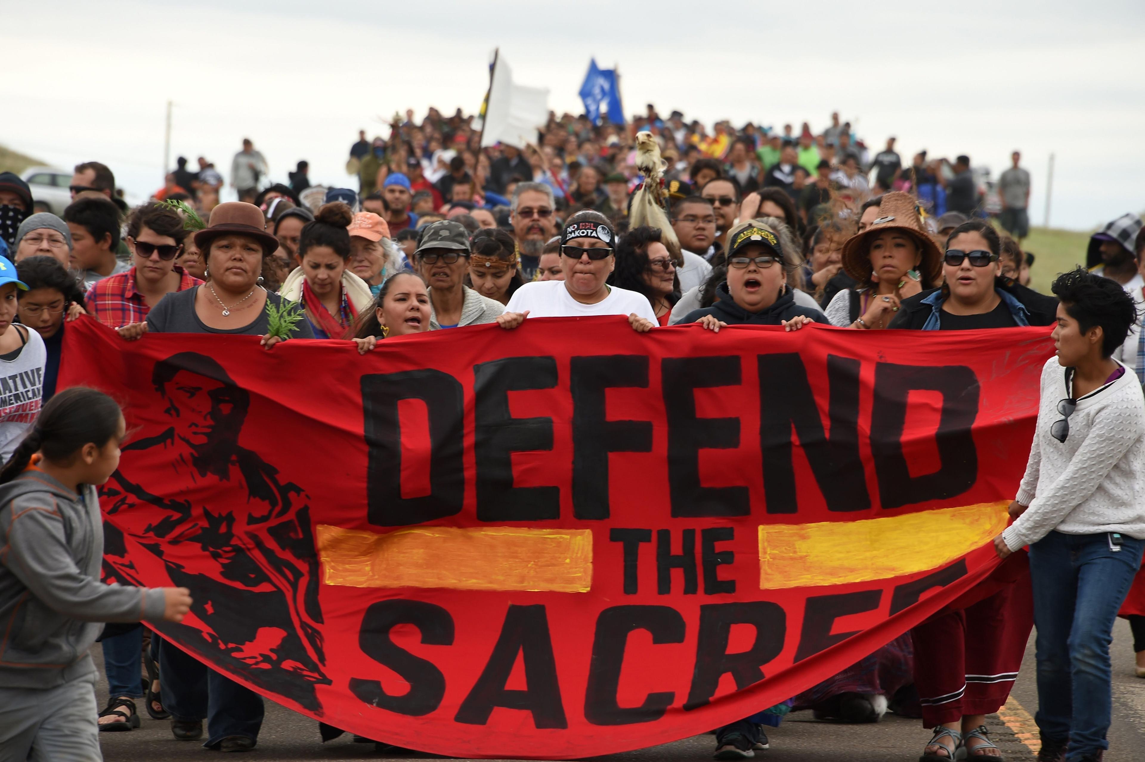 Native Americans march to a burial ground sacred site that was disturbed by bulldozers building the Dakota Access Pipeline (DAPL), near the encampment where hundreds of people have gathered to join the Standing Rock Sioux Tribe's protest of the oil pipel