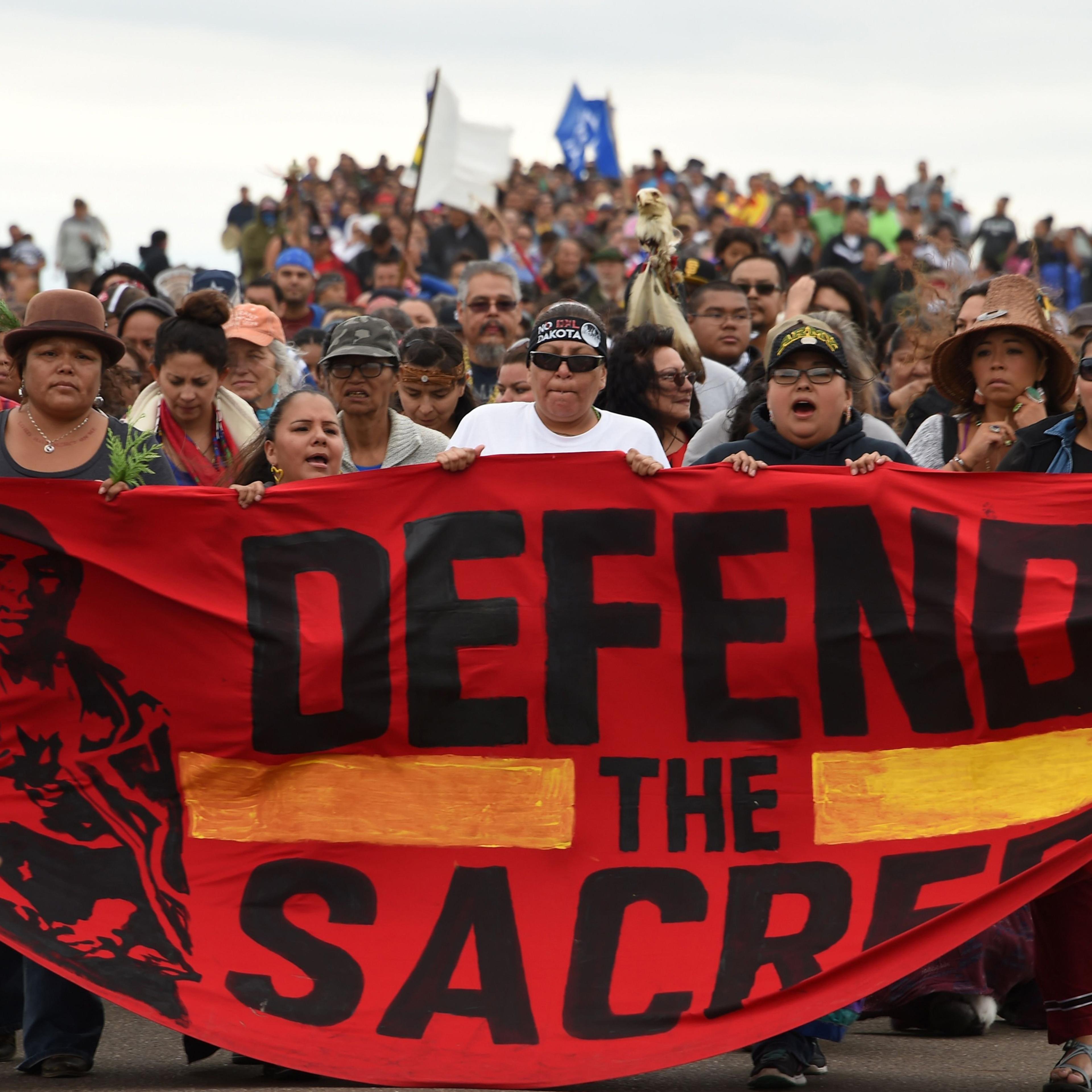 Native Americans march to a burial ground sacred site that was disturbed by bulldozers building the Dakota Access Pipeline (DAPL), near the encampment where hundreds of people have gathered to join the Standing Rock Sioux Tribe's protest of the oil pipel