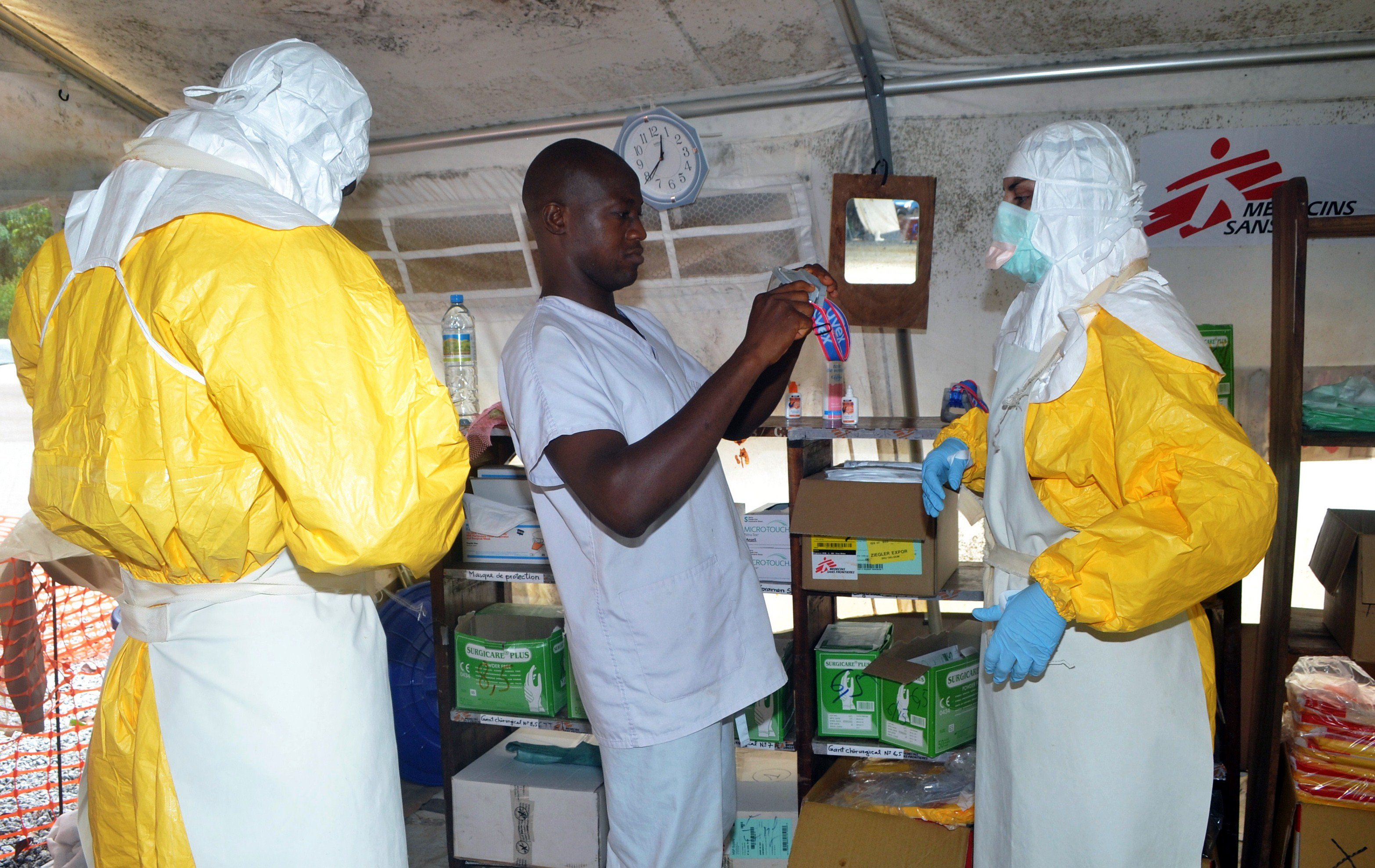 Members of Doctors Without Borders (MSF) put on protective gear at the isolation ward of the Donka Hospital in Conakry, Guinea on July 23, 2014.