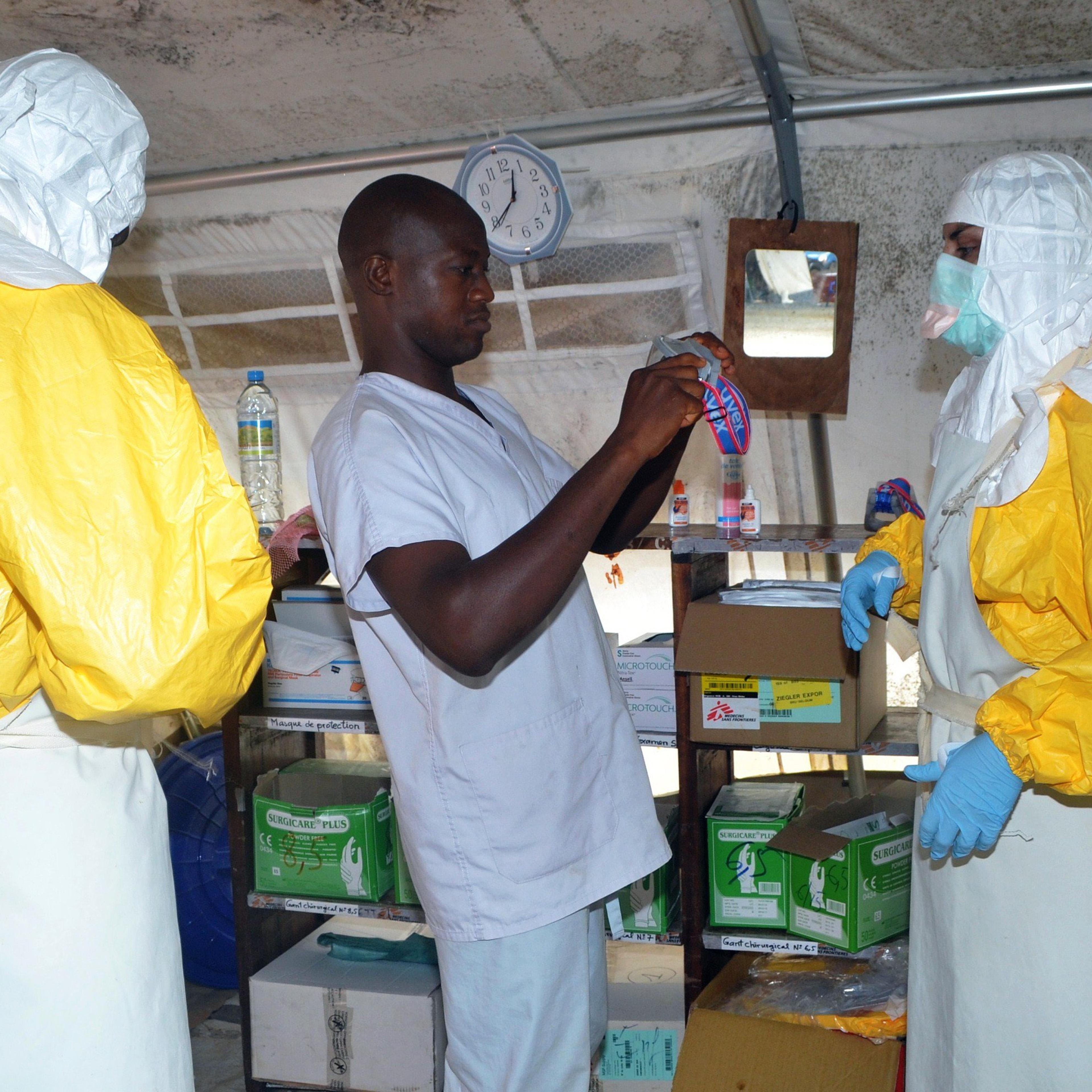 Members of Doctors Without Borders (MSF) put on protective gear at the isolation ward of the Donka Hospital in Conakry, Guinea on July 23, 2014.