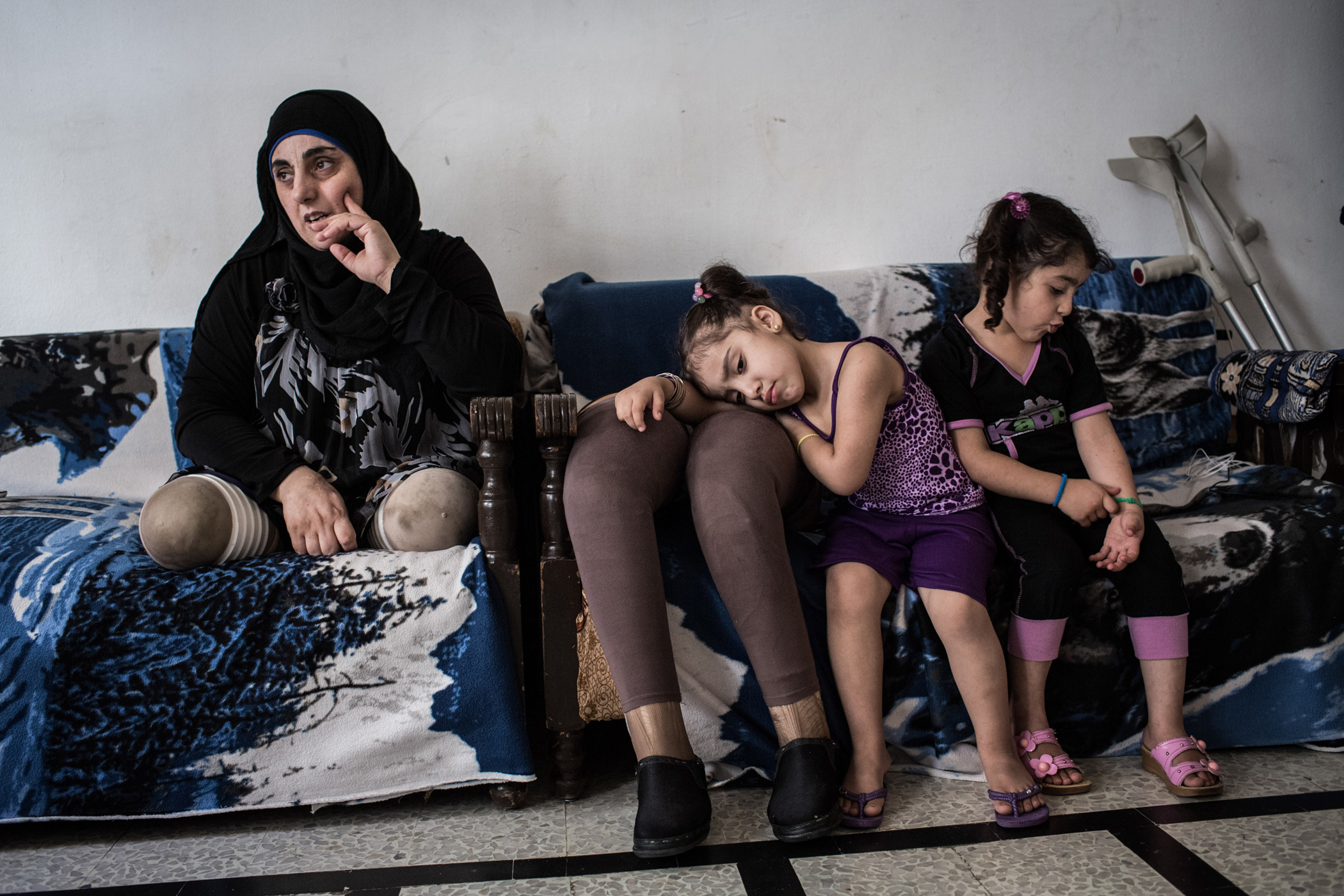 Hasna, pictured with her nieces, Aseel and Hadeel, 4, in their shared home in Tripoli, on June 11, 2014.  In March 2012, Hasna, her husband and her two children were traveling on a motorcycle in Qusayr when a bomb fell nearby: “My daughter was sleeping i