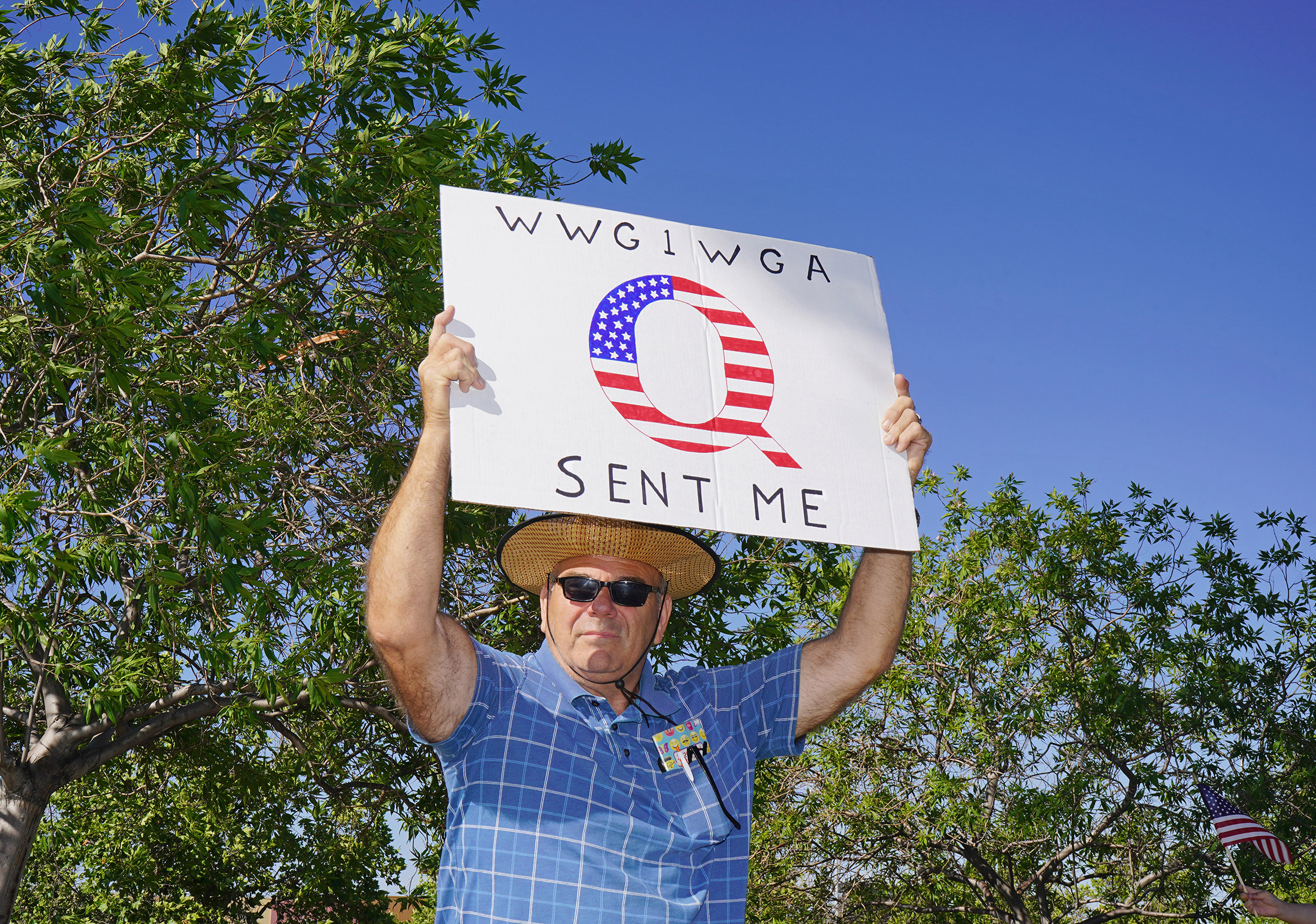A protester with a QAnon sign at an anti-lockdown rally in Santa Clarita, Calif., May 21, 2020.