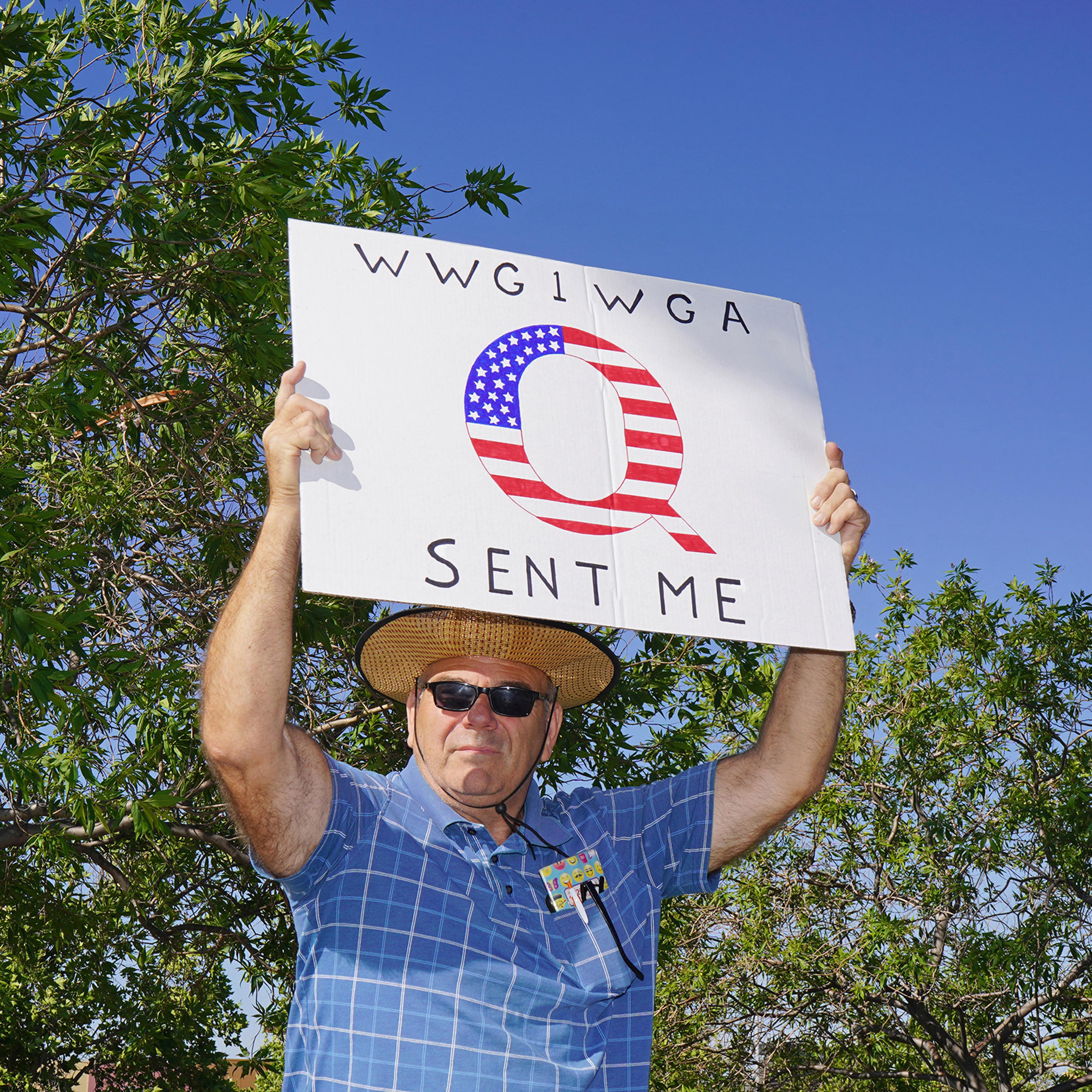 A protester with a QAnon sign at an anti-lockdown rally in Santa Clarita, Calif., May 21, 2020.