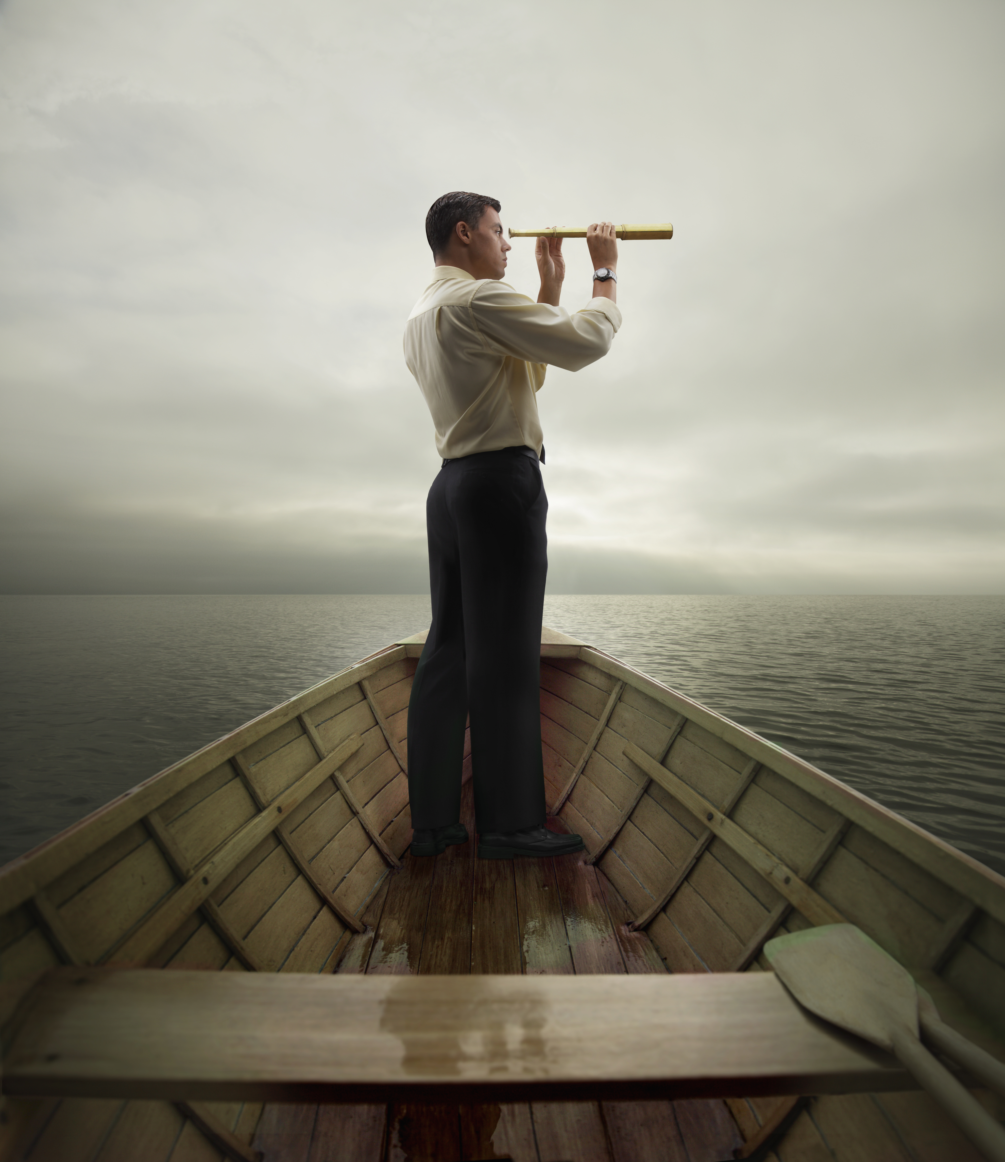 man-looking-through-spyglass