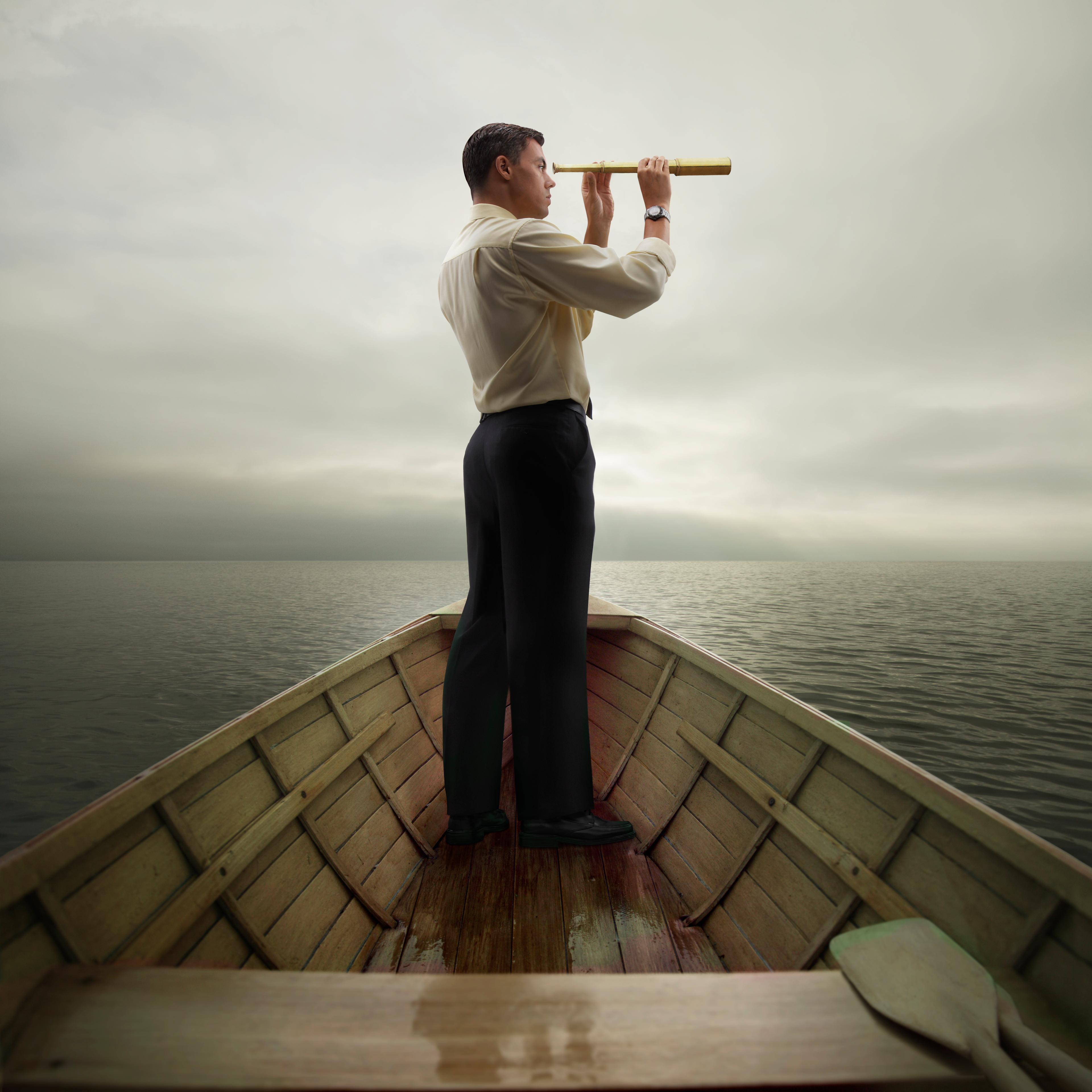 man-looking-through-spyglass