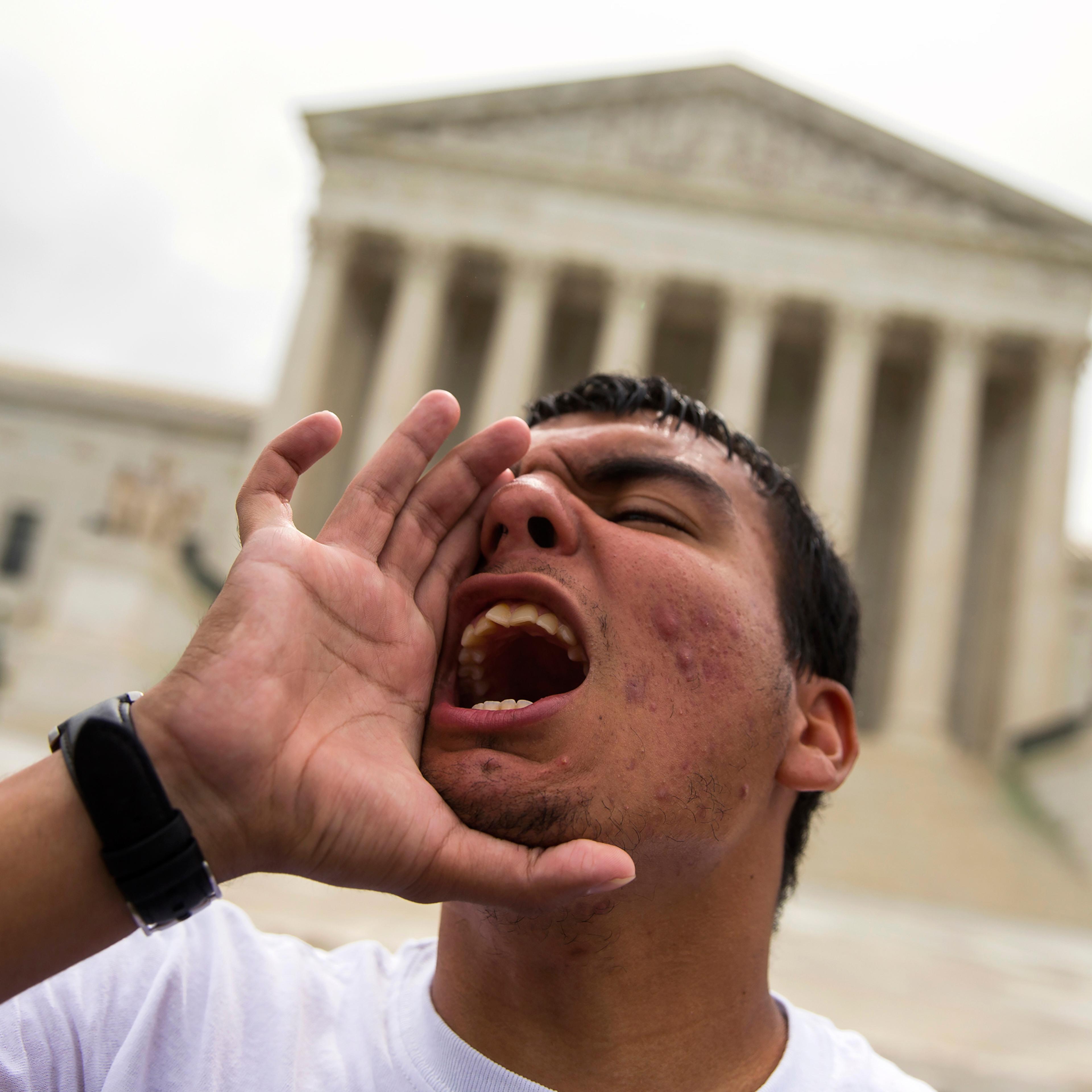 Gerson Quinteron of Washington, yells during a demonstration on immigration at the Supreme Court in Washington, Thursday, June 23, 2016. A tie vote by the Supreme Court is blocking President Barack Obama's immigration plan that sought to shield millions