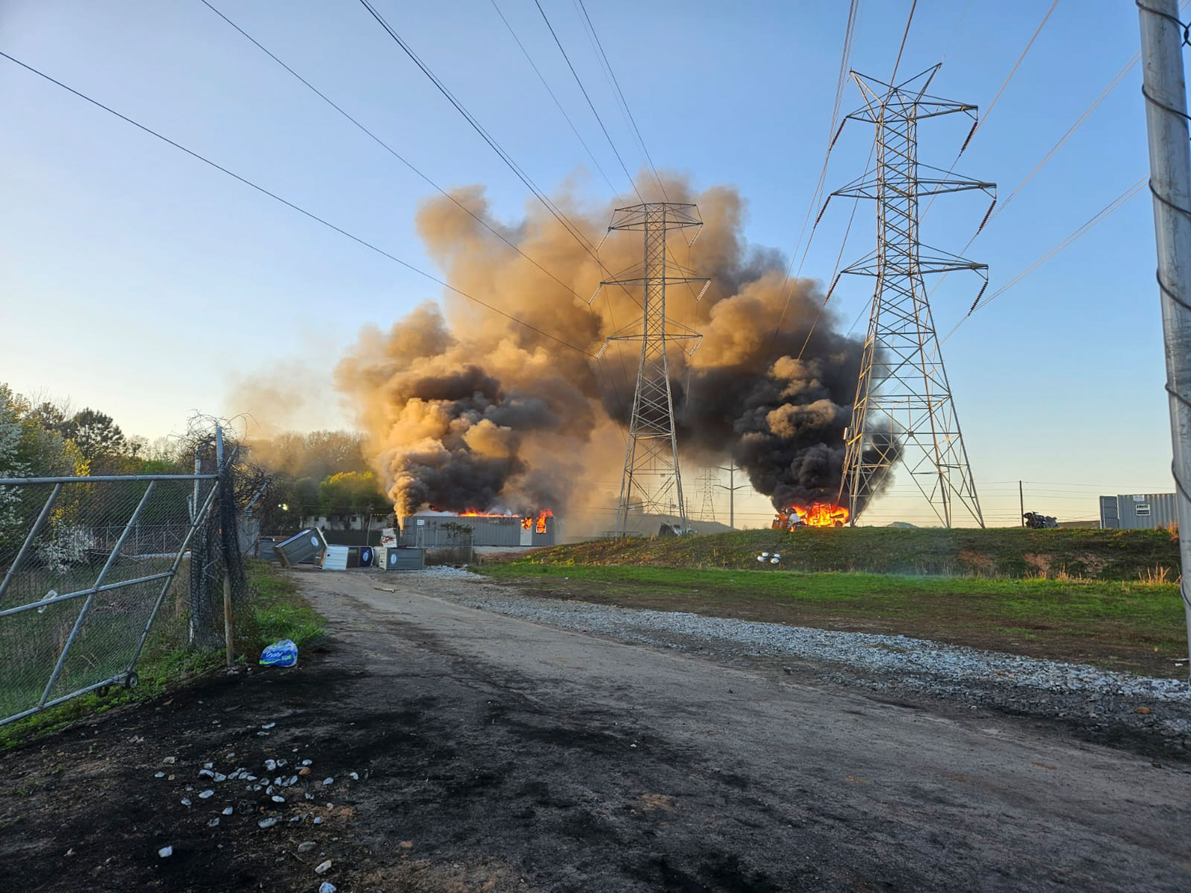 Smoke rises after protesters breached Cop City in Dekalb County, outside Atlanta, on Sunday, Oct. 5, 2023. (Sean Keenan/The New York Times)