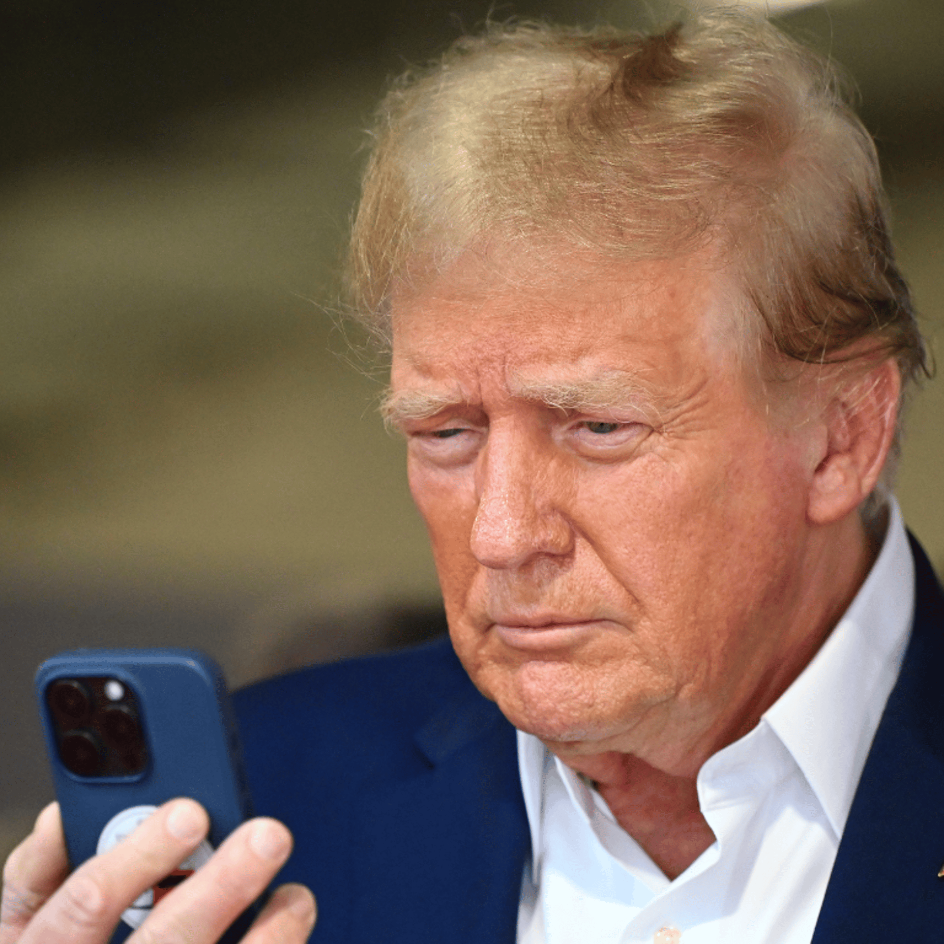 Donald Trump talks on the phone in the McLaren garage prior to the F1 Grand Prix of Miami at Miami International Autodrome in Miami, Fla., on May 5, 2024.