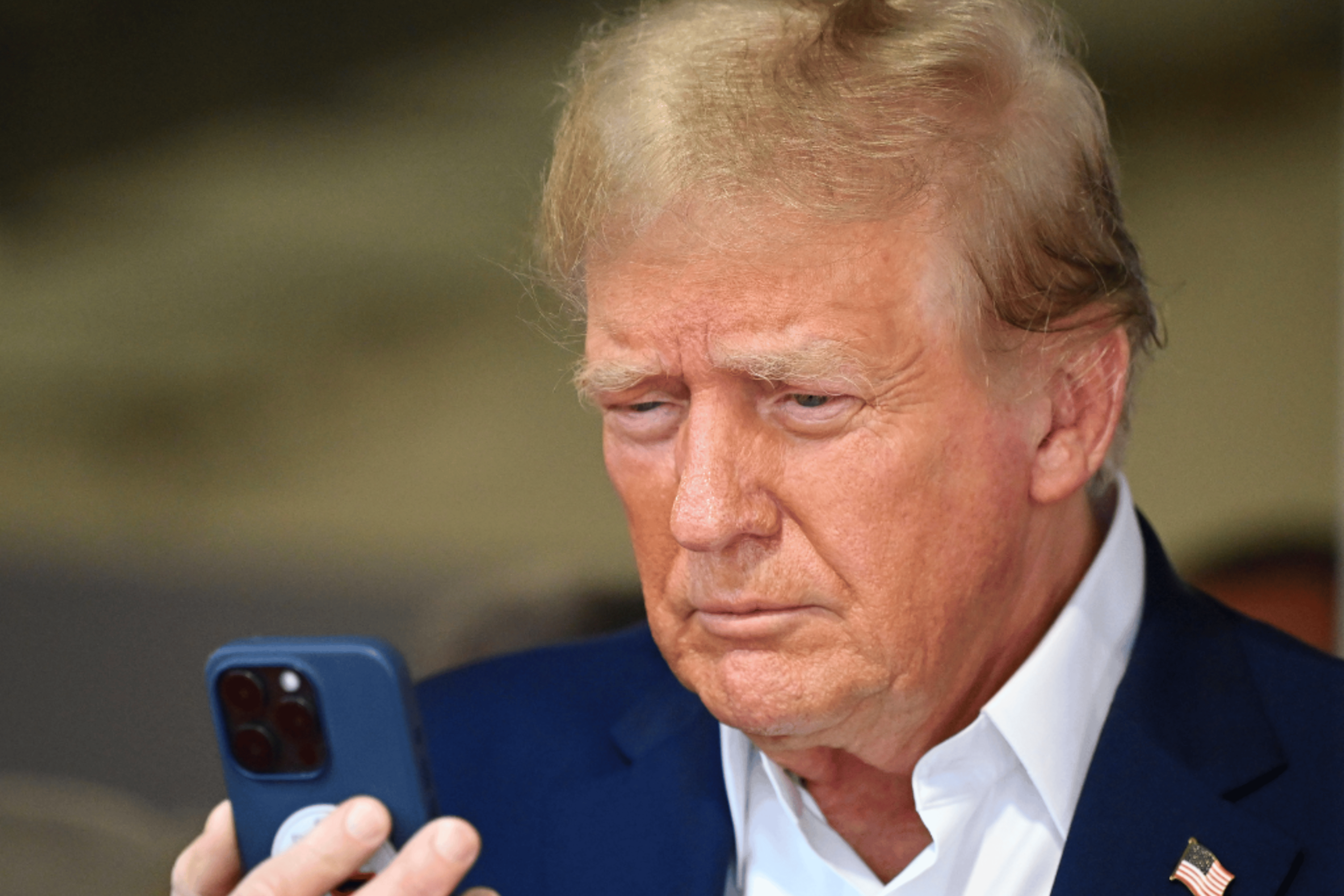 Donald Trump talks on the phone in the McLaren garage prior to the F1 Grand Prix of Miami at Miami International Autodrome in Miami, Fla., on May 5, 2024.
