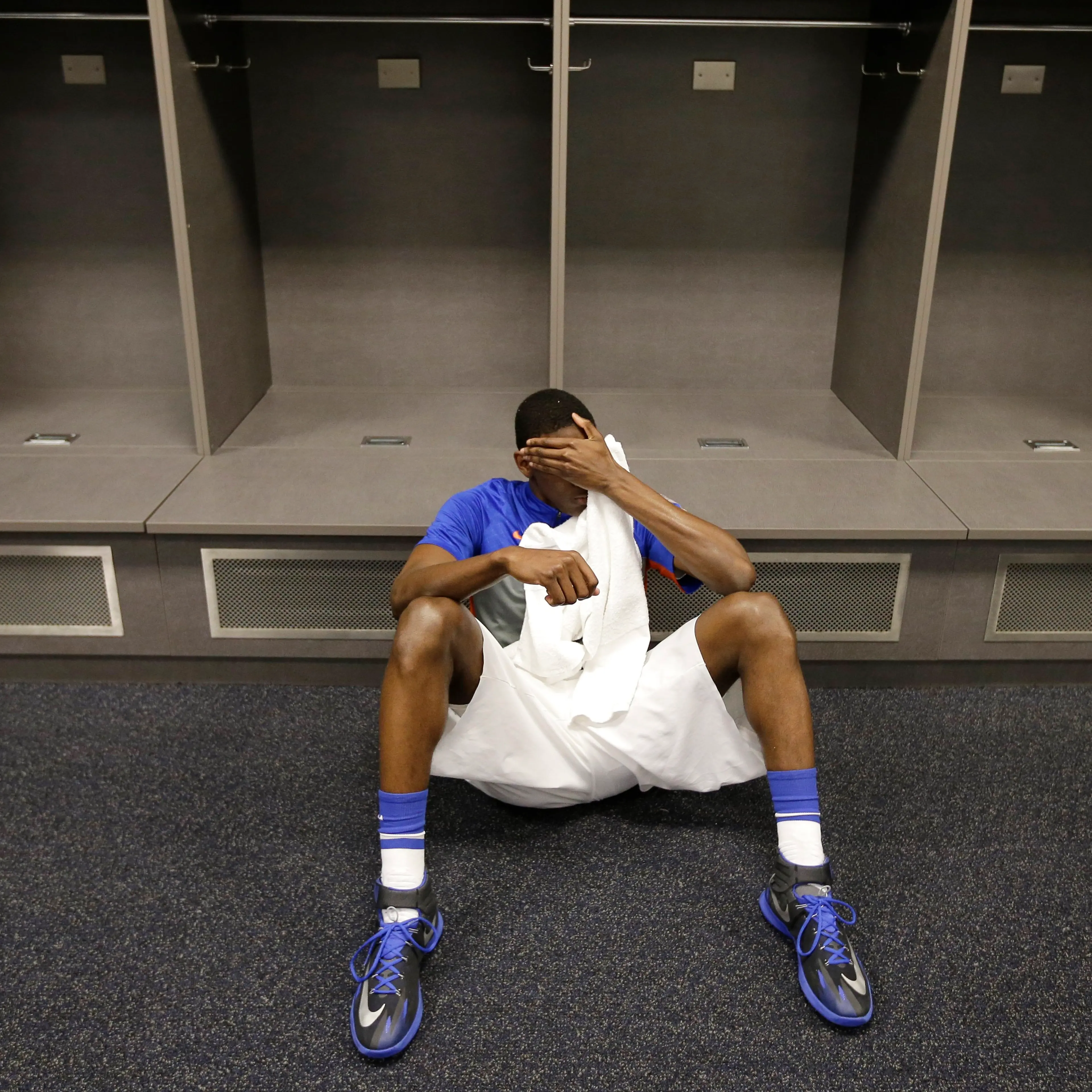 Florida forward Dorian Finney-Smith rests on the floor of the locker room after losing to Connecticut in the NCAA Tournament Final Four, April 5, 2014, in Arlington, Texas. Connecticut won 63-53.