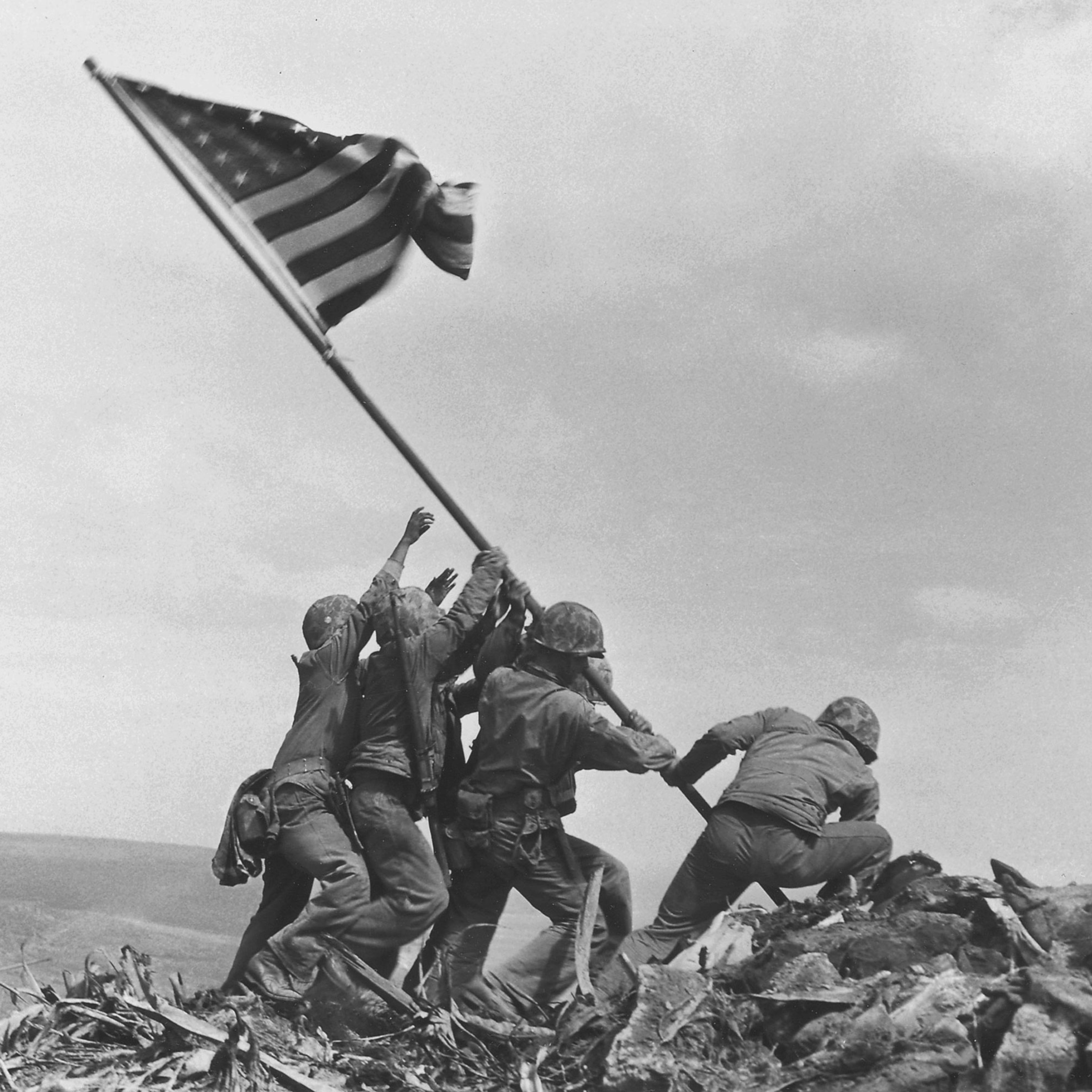 U.S. Marines of the 28th Regiment, 5th Division, raise the American flag atop Mt. Suribachi, Iwo Jima, on Feb. 23, 1945.