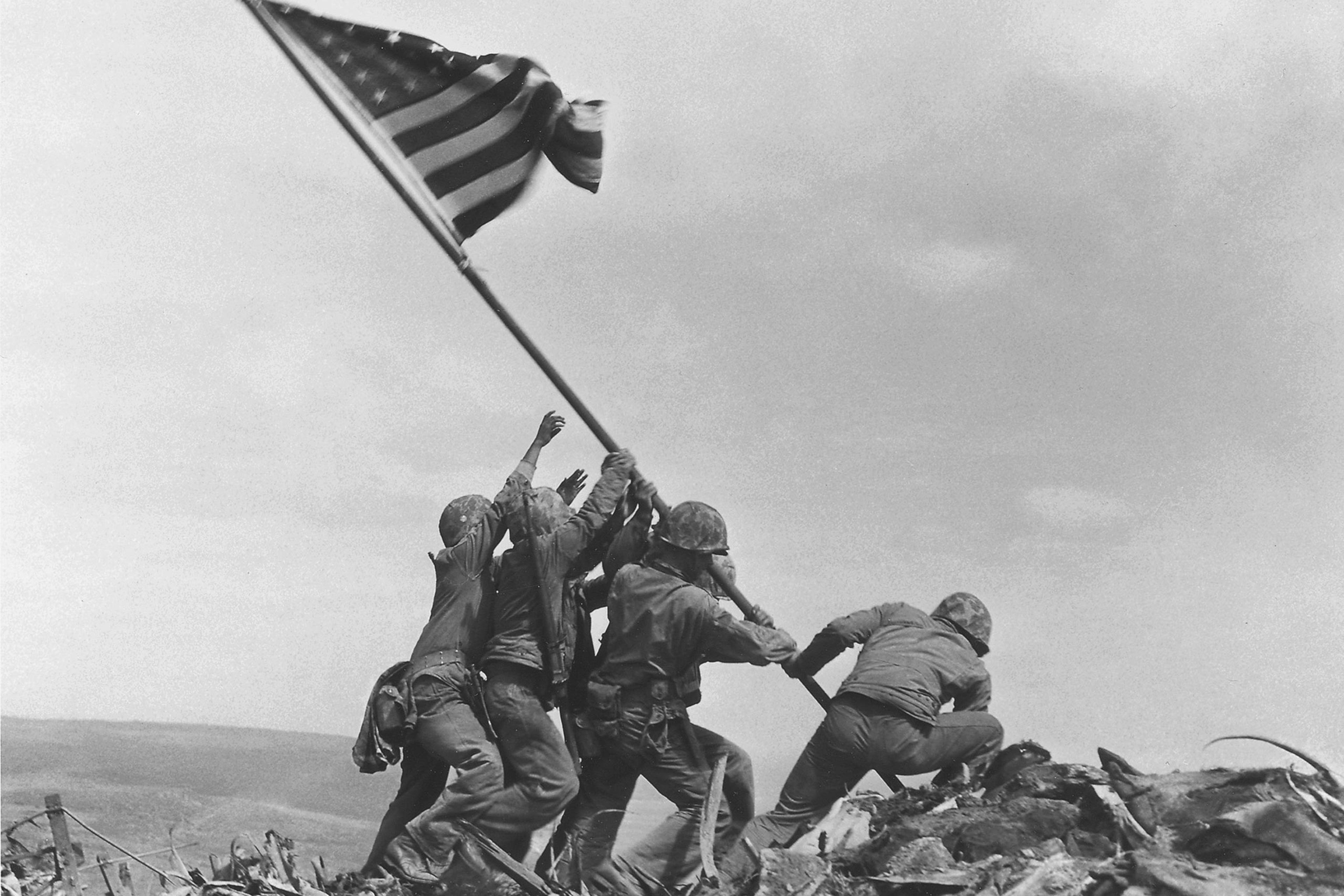 U.S. Marines of the 28th Regiment, 5th Division, raise the American flag atop Mt. Suribachi, Iwo Jima, on Feb. 23, 1945.
