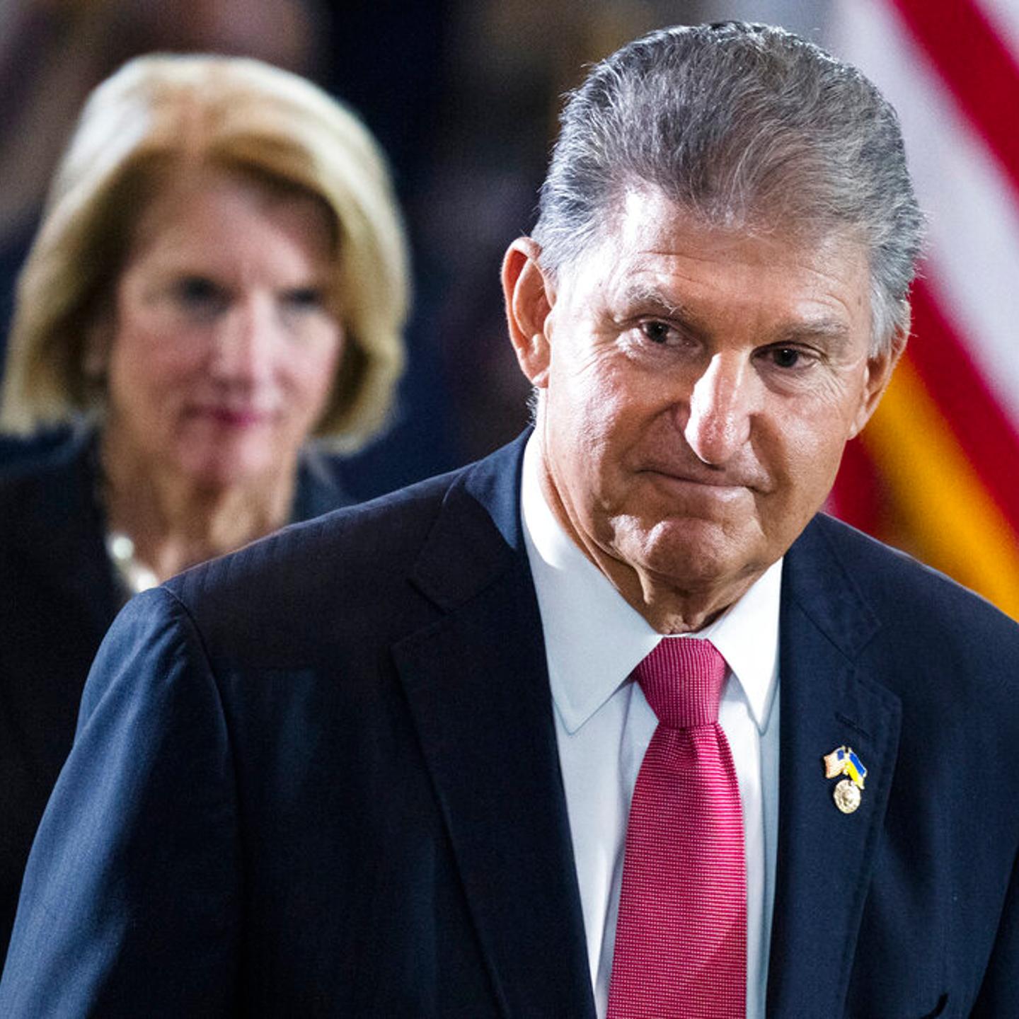 Sen. Joe Manchin, D-W.Va., and Sen. Shelley Moore Capito, R-W.Va., pay their respects as the flag-draped casket bearing the remains of Hershel W. "Woody" Williams, lies in honor in the U.S. Capitol, Thursday, July 14, 2022 in Washington.