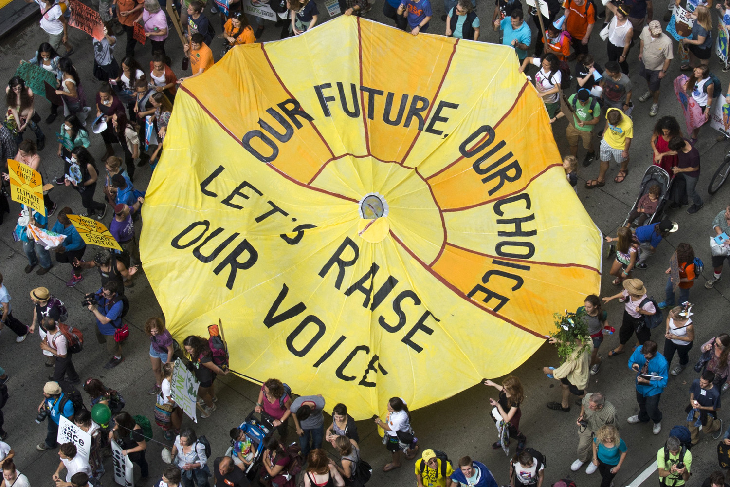Some of hundreds of thousands take part in the People's Climate March through Midtown, New York