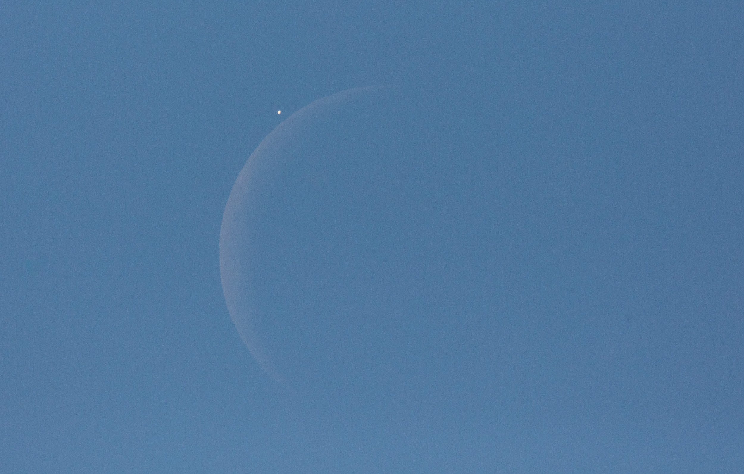 Venus is seen next to the crescent moon during the daytime, prior to the start of occultation in Washington, D.C. on Dec. 7, 2015. The moon had occulted, or passed in front of, Venus for the second time that year.