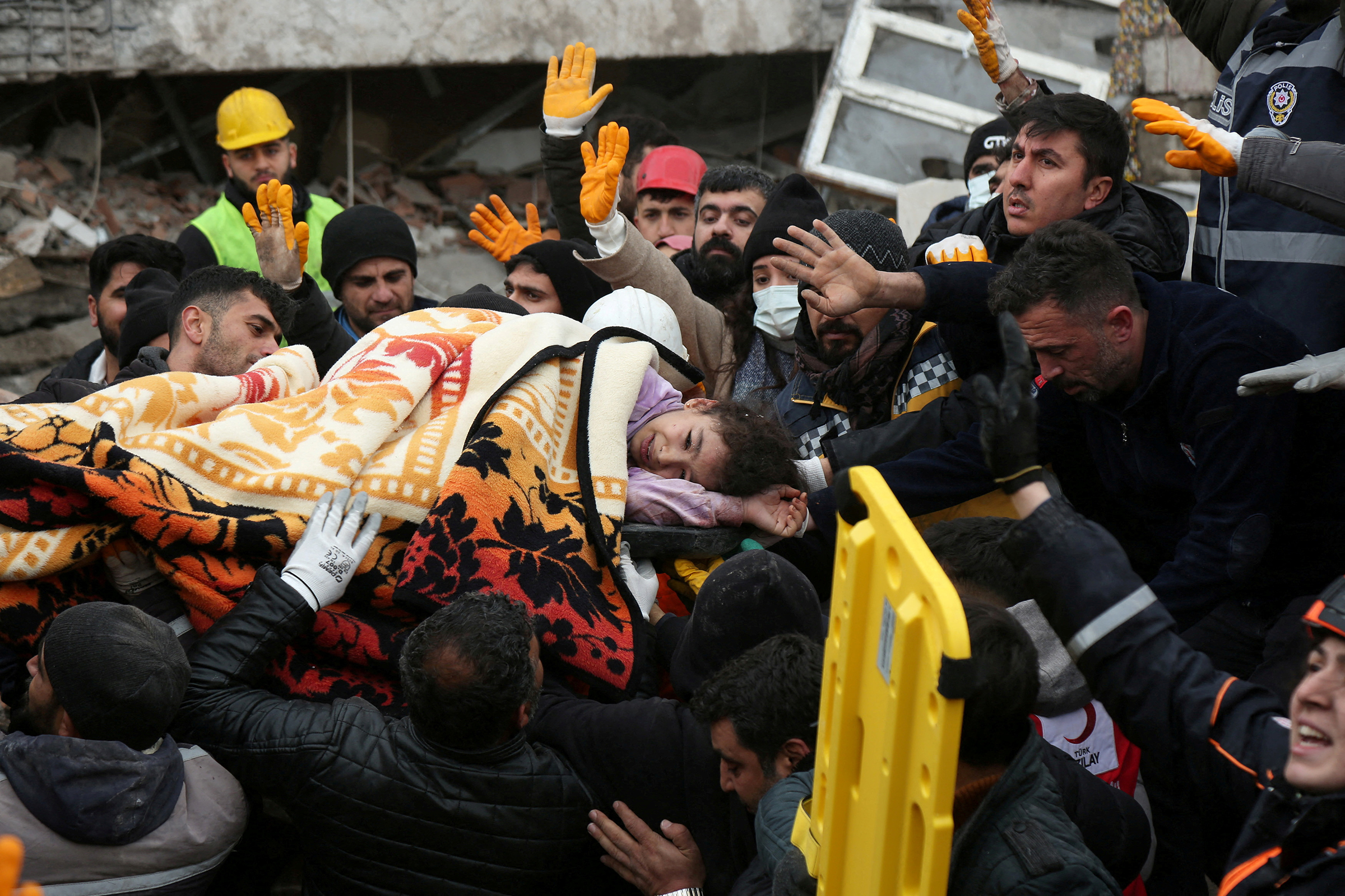 Rescuers carry a girl from a collapsed building following an earthquake in Diyarbakir, Turkey on February 6, 2023.  