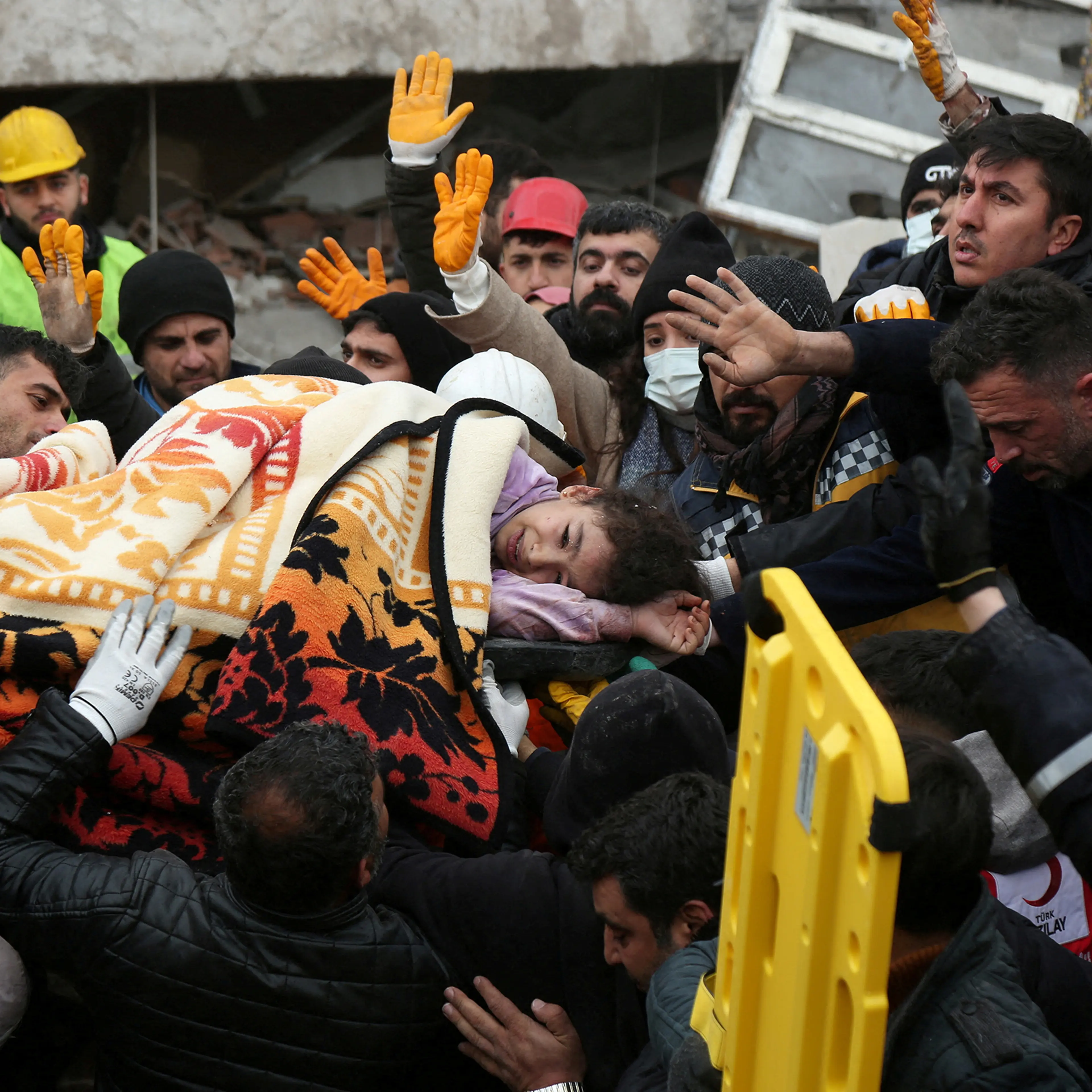 Rescuers carry a girl from a collapsed building following an earthquake in Diyarbakir, Turkey on February 6, 2023.
