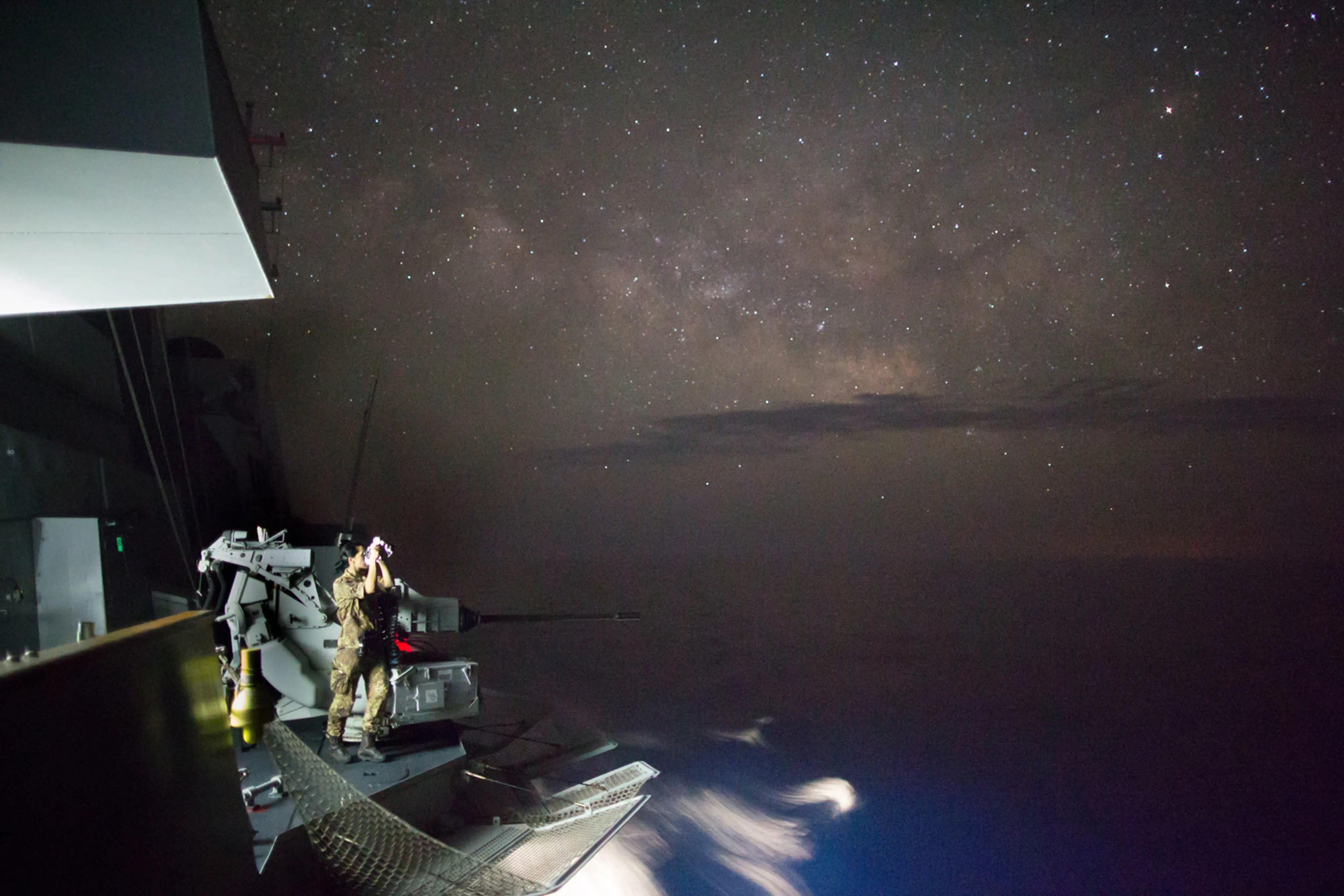 A soldier using binoculars to spot boats carrying asylum seekers in the Mediterranean Sea, June 2.