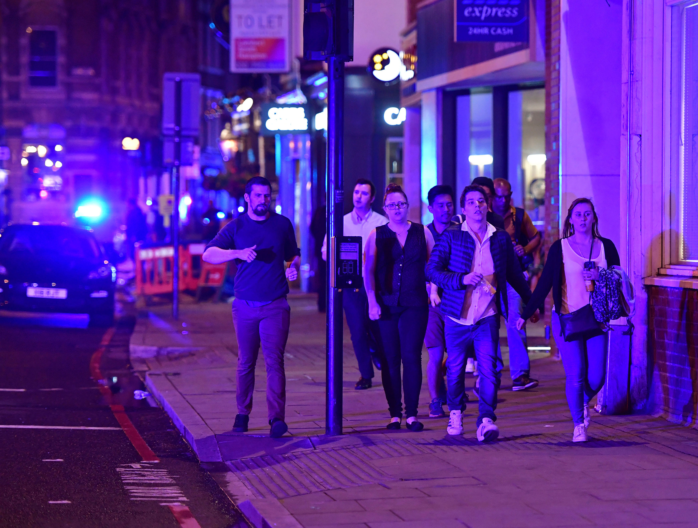 People run down Borough High Street as police are dealing with a "major incident" at London Bridge on June 3, 2017.
