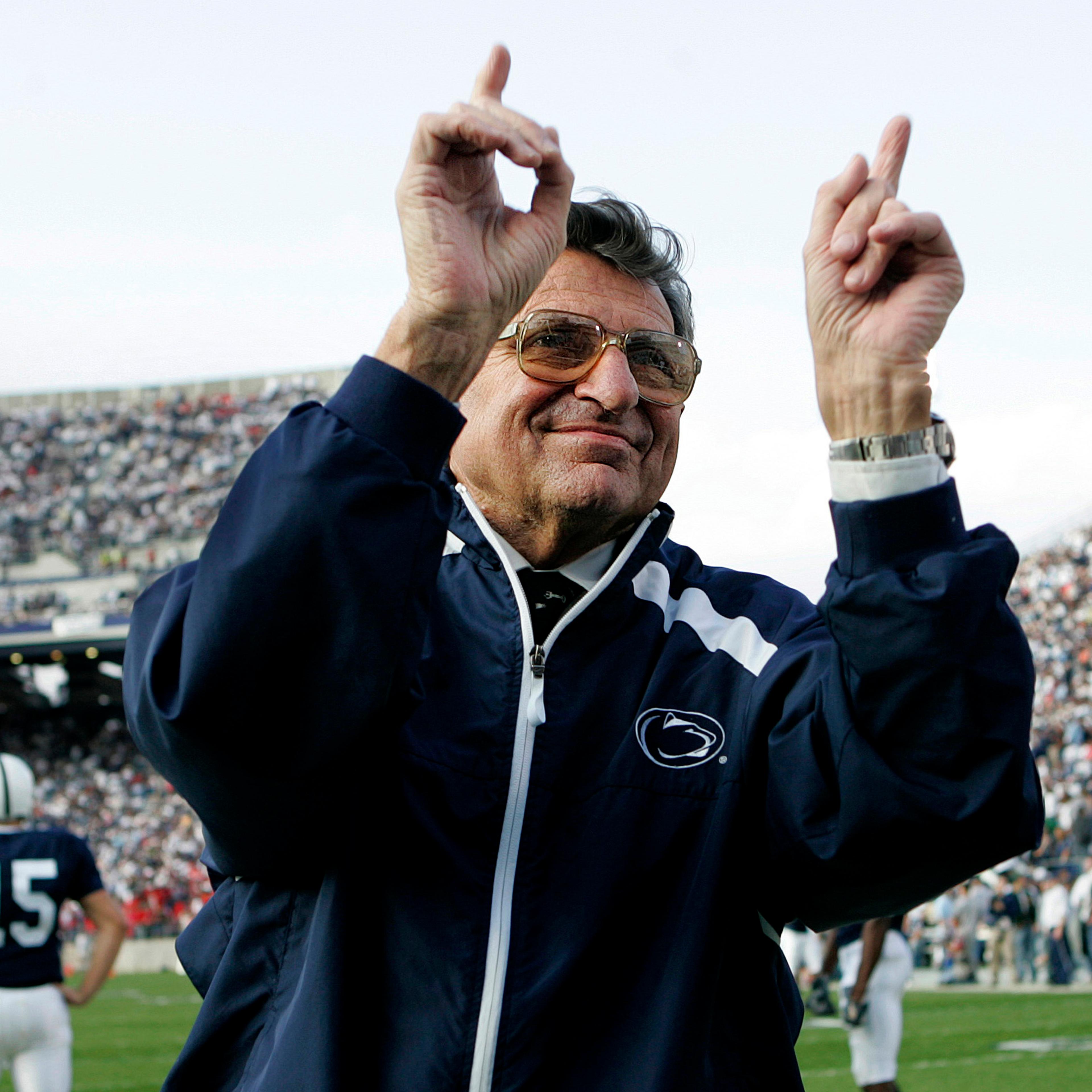 Penn State football coach Joe Paterno acknowledges the crowd before an NCAA college football game against Wisconsin in State College, Pa. on Nov. 5, 2005.
