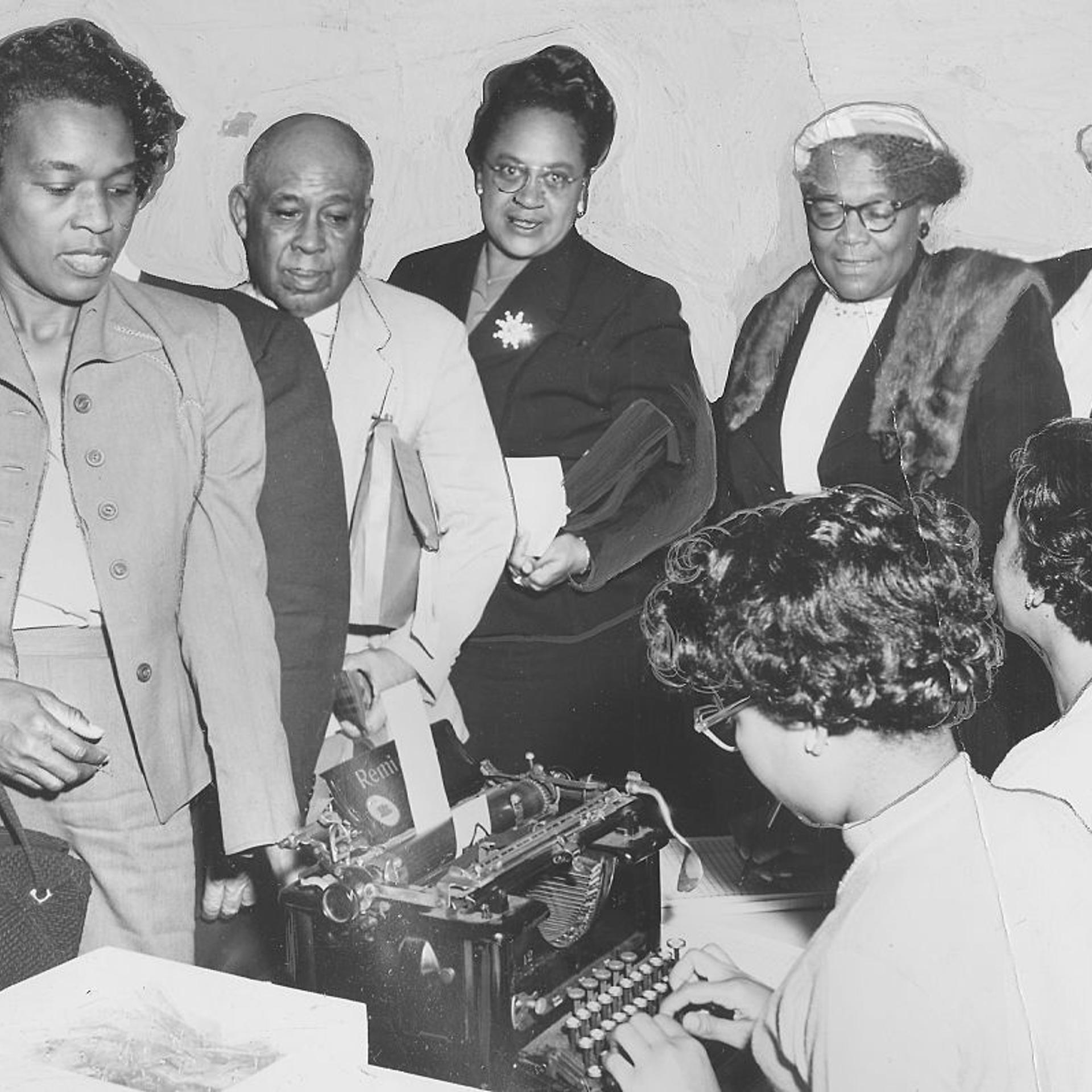 Black men and women registering to vote in 1958