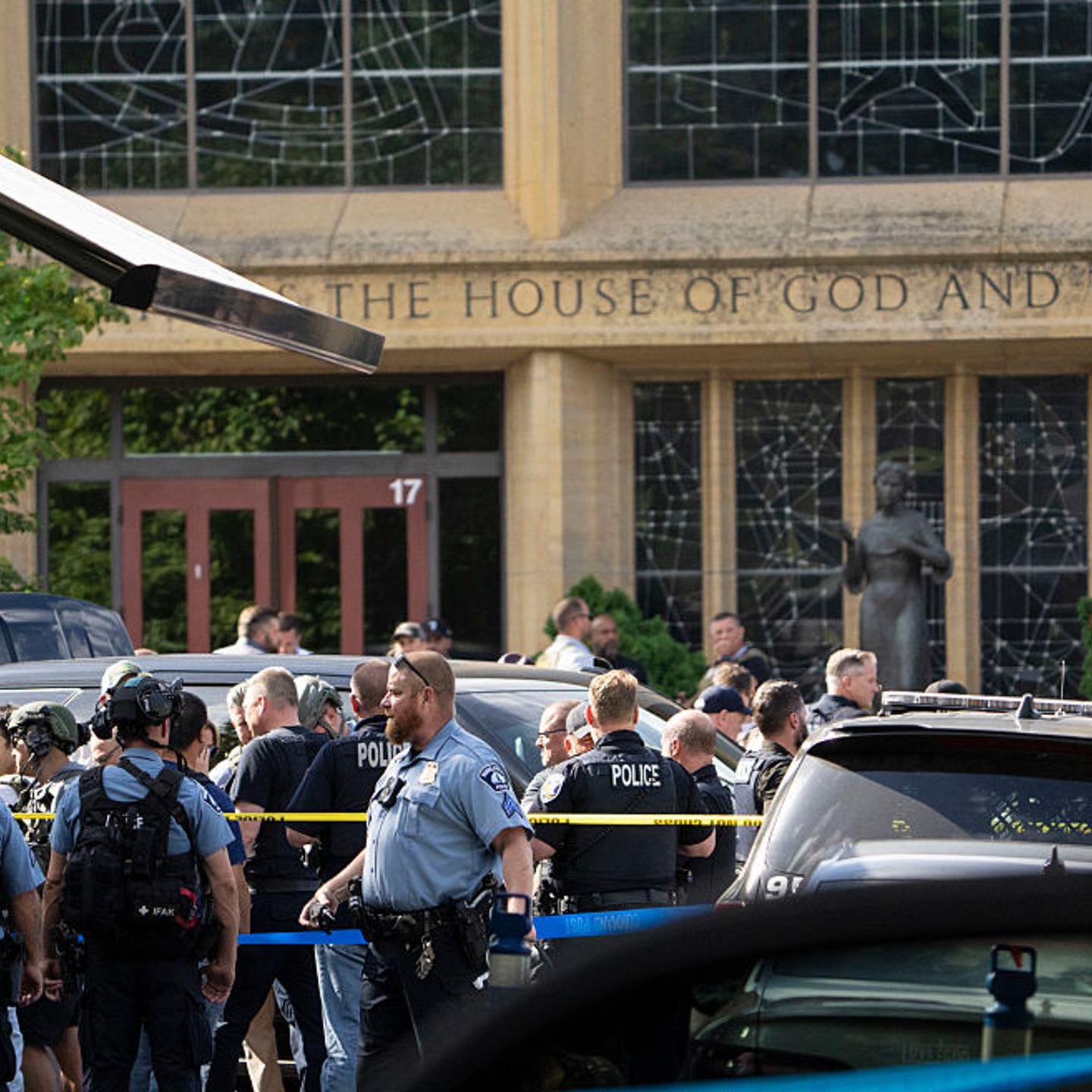 Dozens of first responders crowd the street in front of Annunciation Catholic Church that was the scene of a shooting that killed two children and wounded seventeen other people in Minneapolis, Minn. on Aug. 27, 2025.