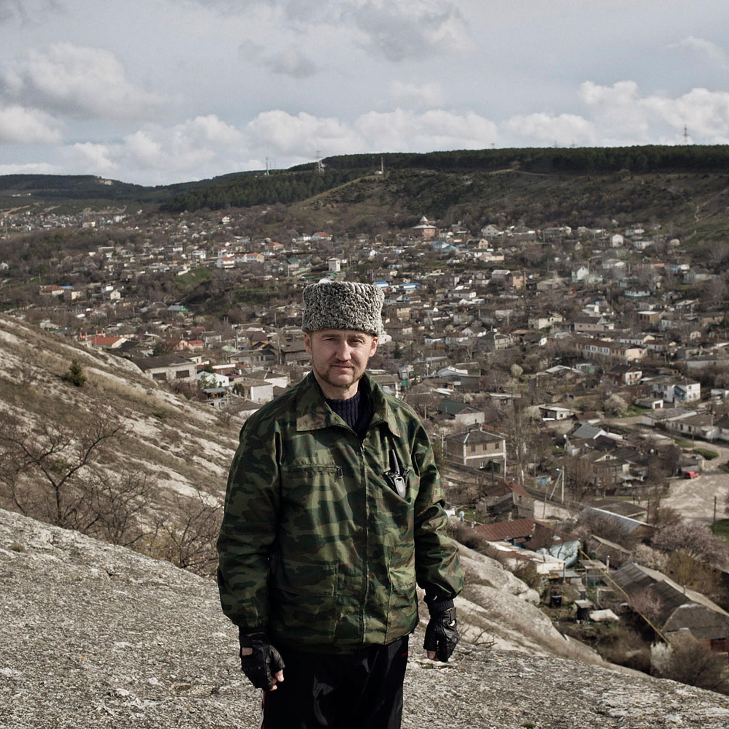 Sergei Yurchenko, the leader of a pro-Russian paramilitary force in Crimea, stands at a lookout point over his hometown Bakhchysarai, on March 16, 2014.