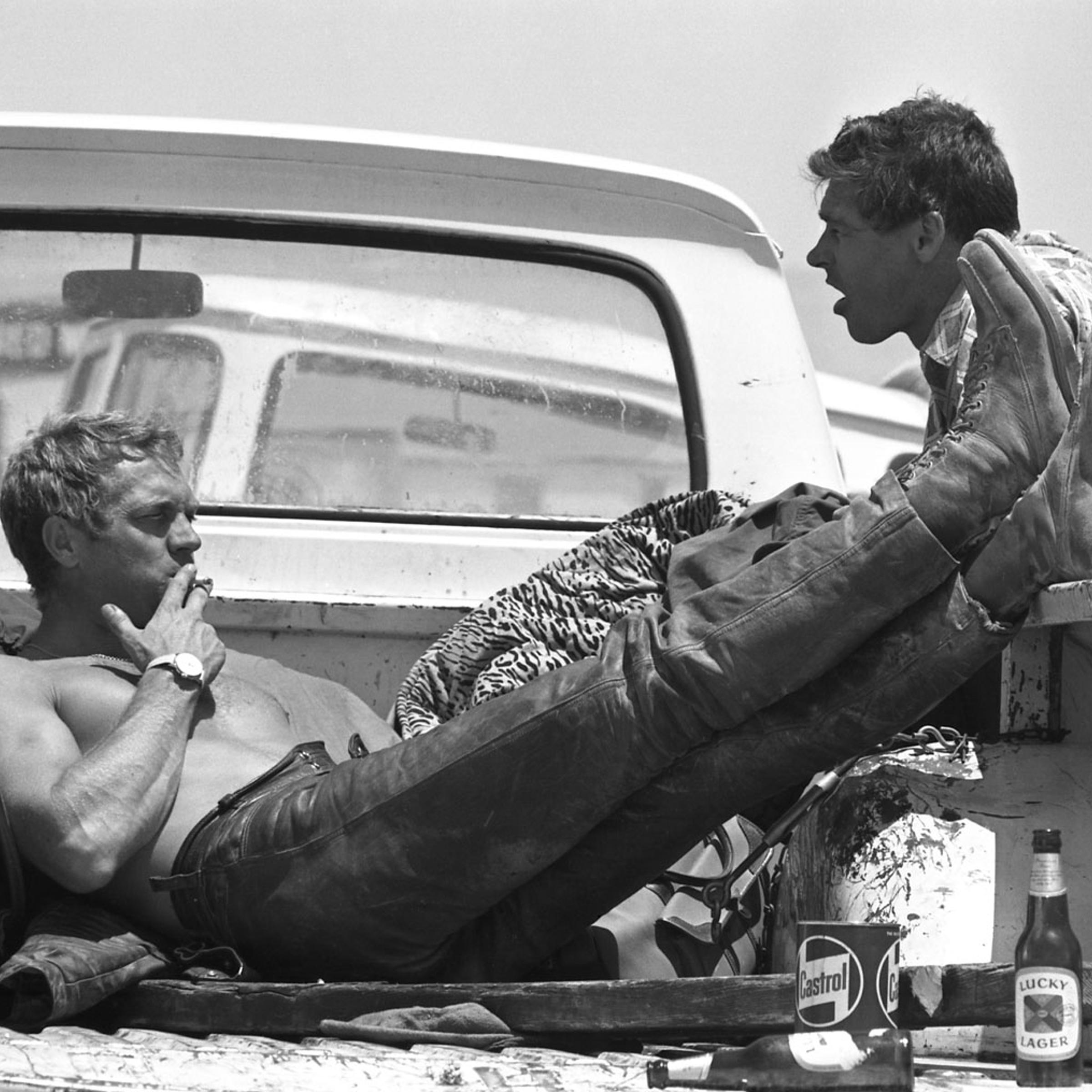 Steve McQueen takes a lunch break during a motorcycle race with Bud Ekins, his friend and stuntman for The Great Escape, 1963.