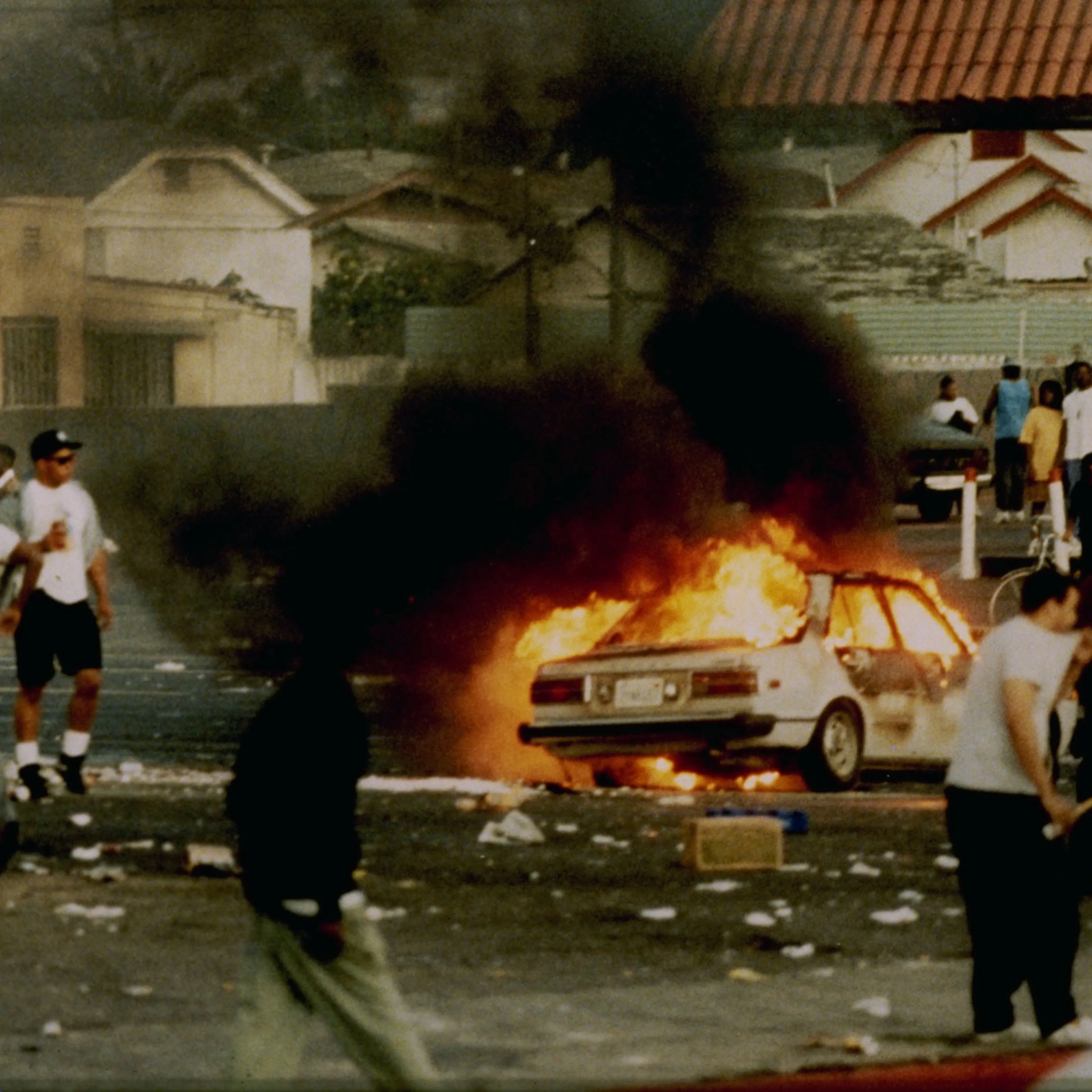 A car burns as looters take to the streets at the intersection of Florence and Normandie Avenues in Los Angeles on April 29, 1992.