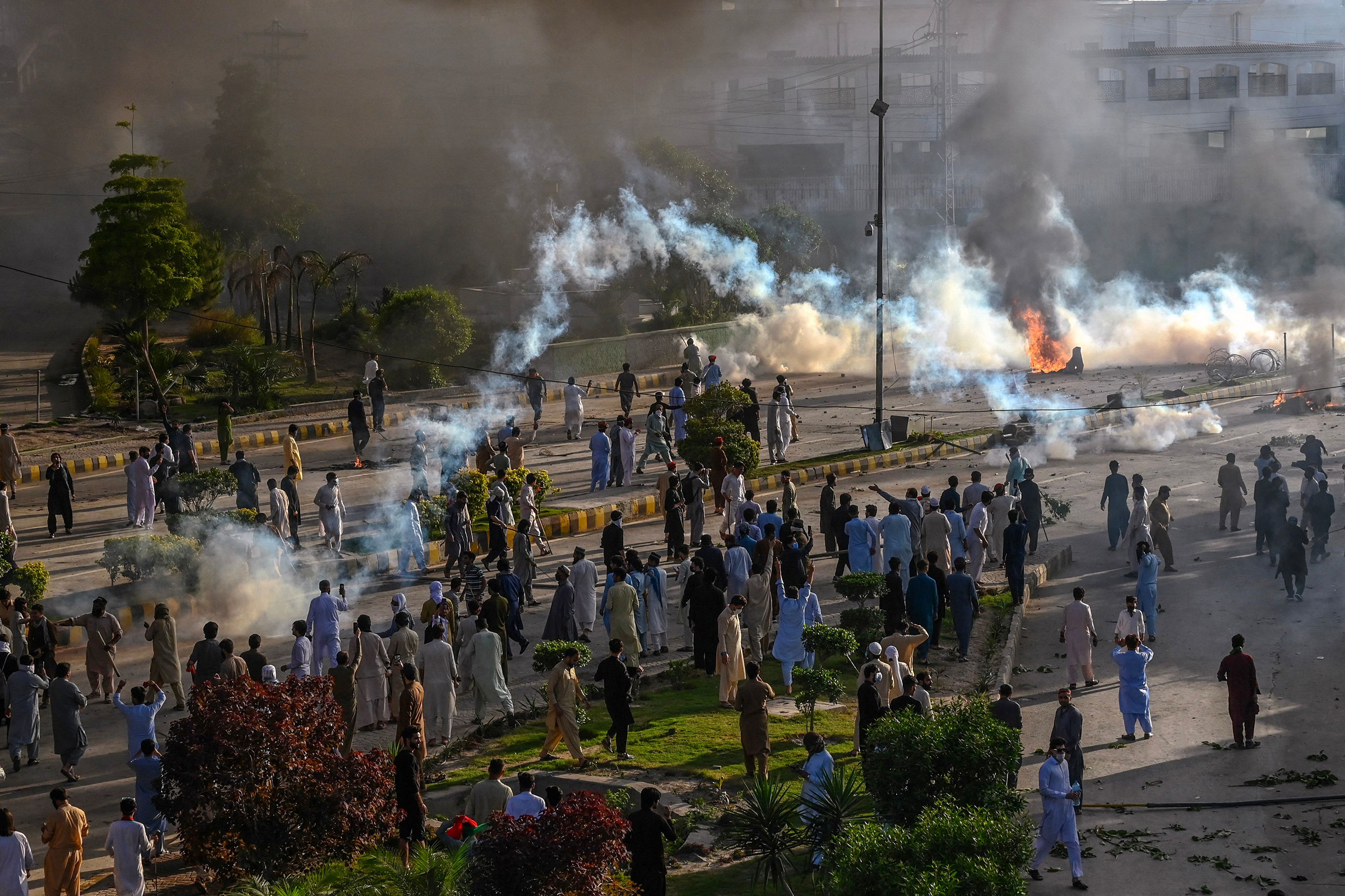 Police fire teargas shell towards Tehreek-e-Insaf party activists and supporters of former Pakistan Prime Minister Imran Khan during a protest against the arrest of their leader in Peshawar on May 9. 