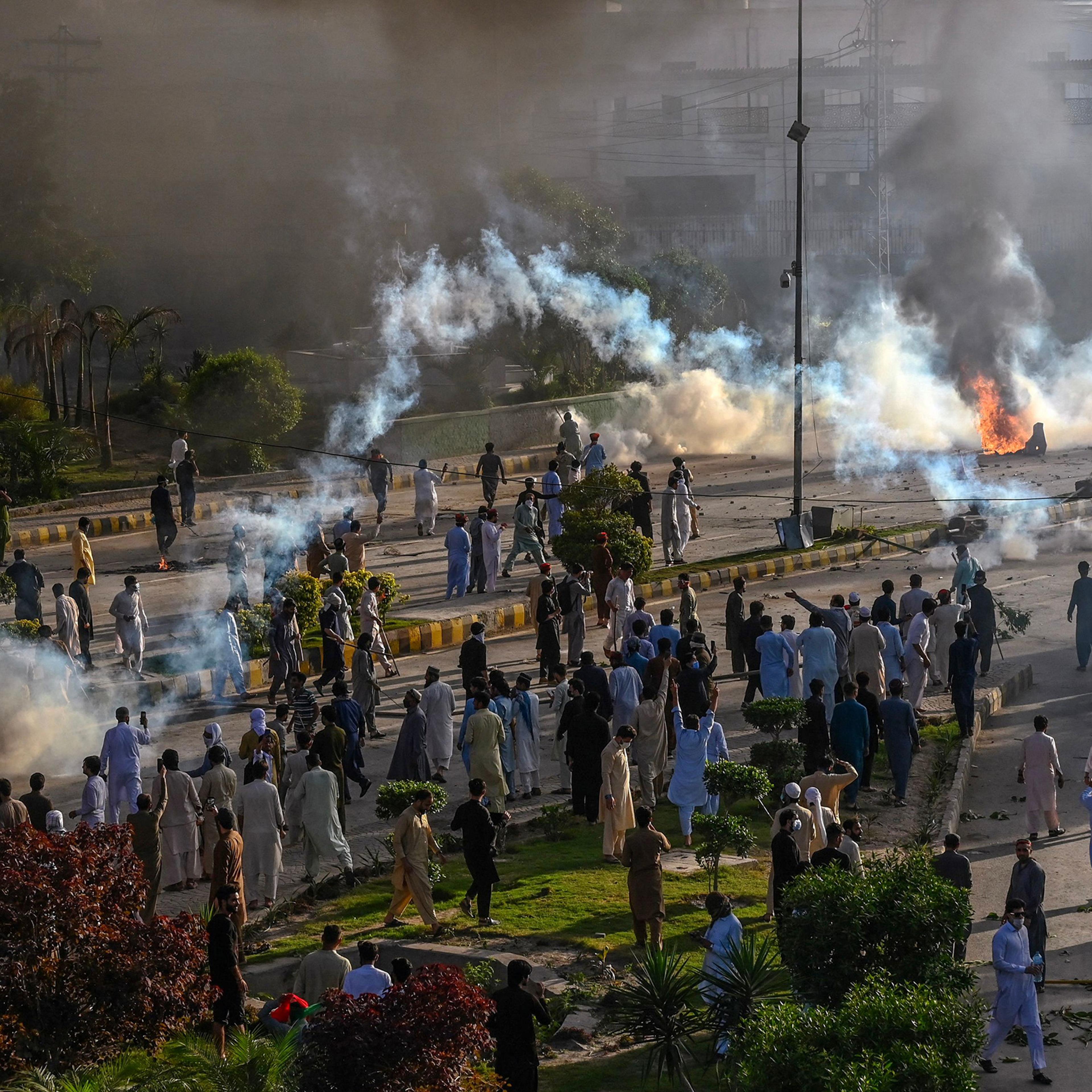 Police fire teargas shell towards Tehreek-e-Insaf party activists and supporters of former Pakistan Prime Minister Imran Khan during a protest against the arrest of their leader in Peshawar on May 9.