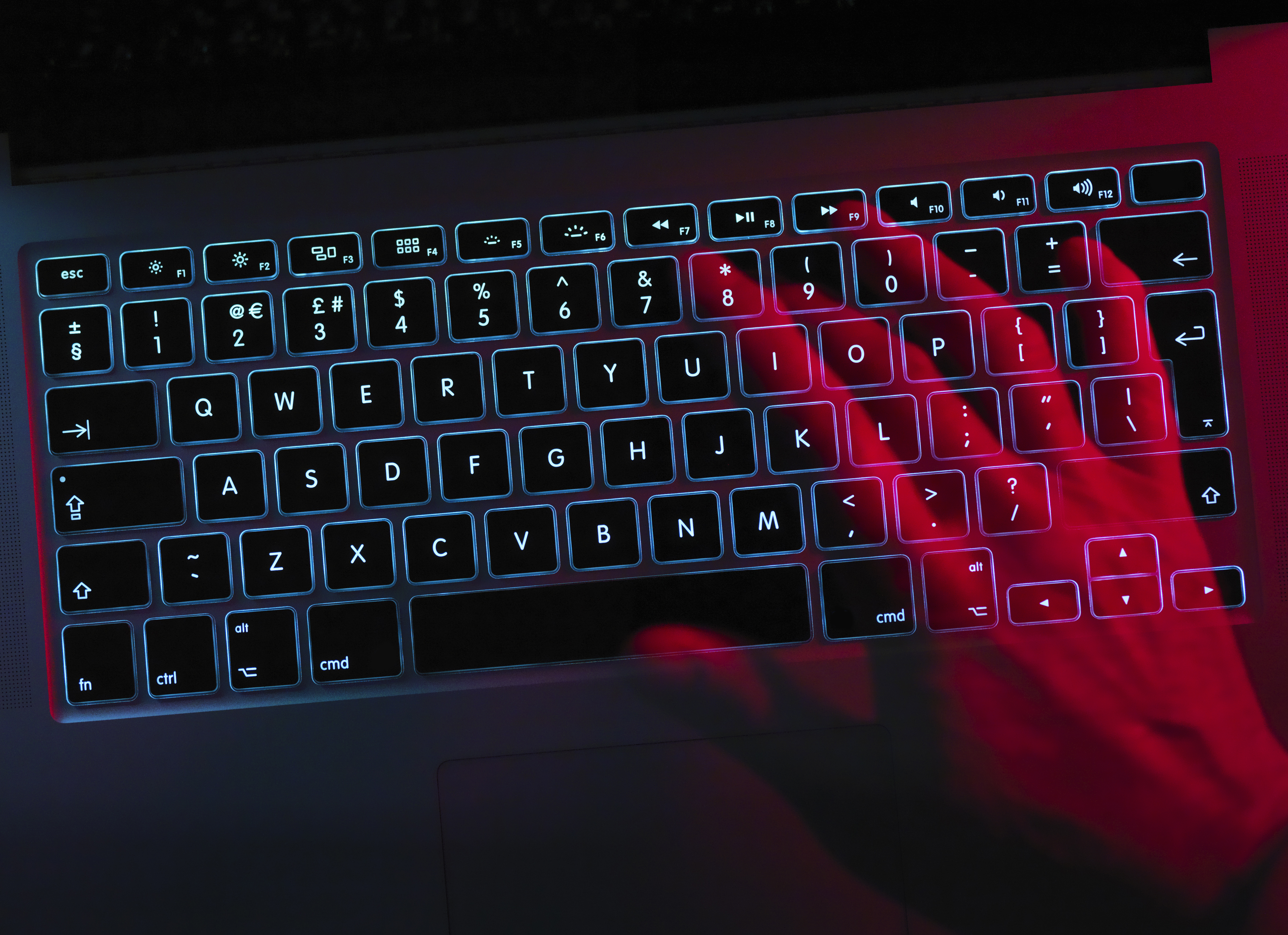 Hand working at laptop computer illustrating cyber crime