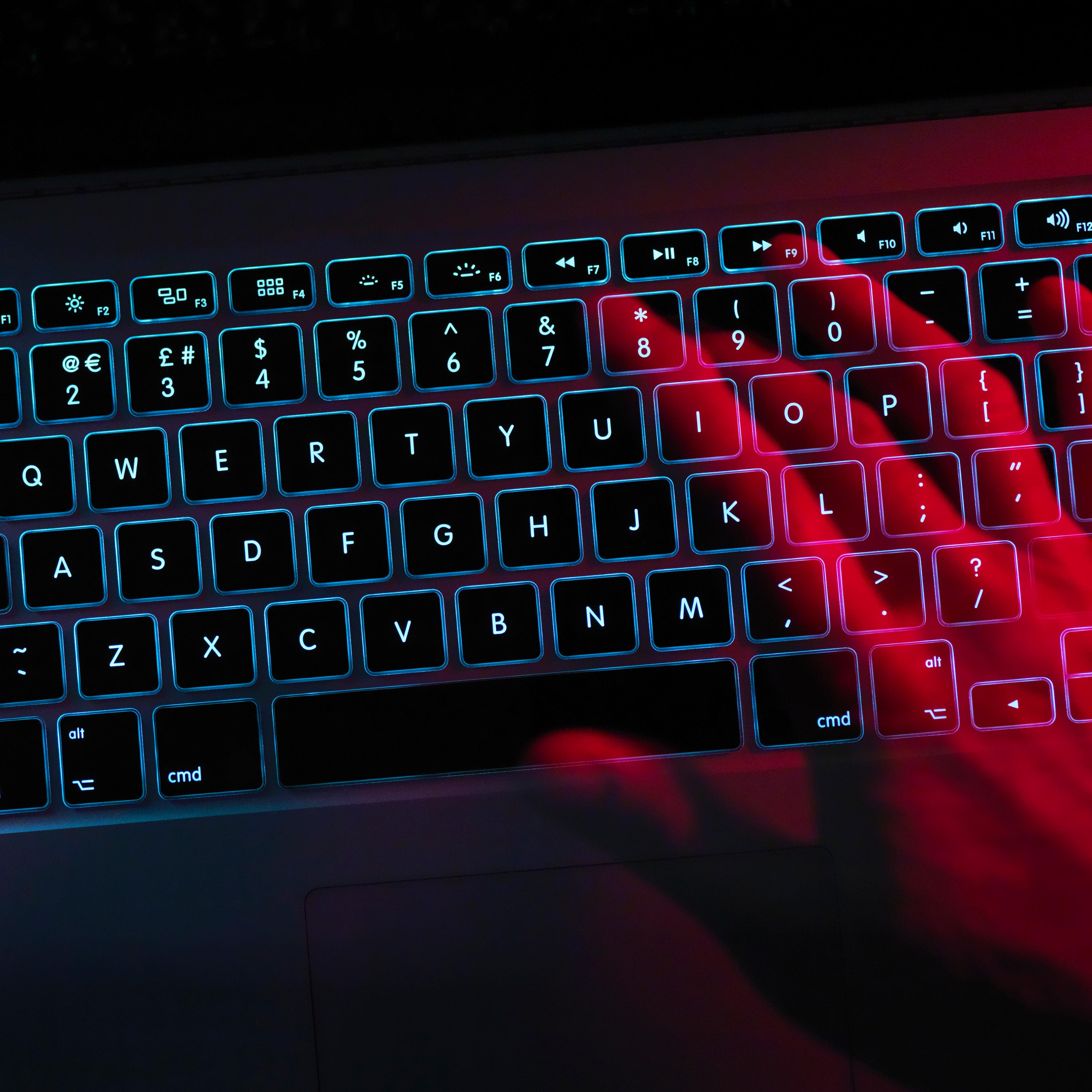 Hand working at laptop computer illustrating cyber crime