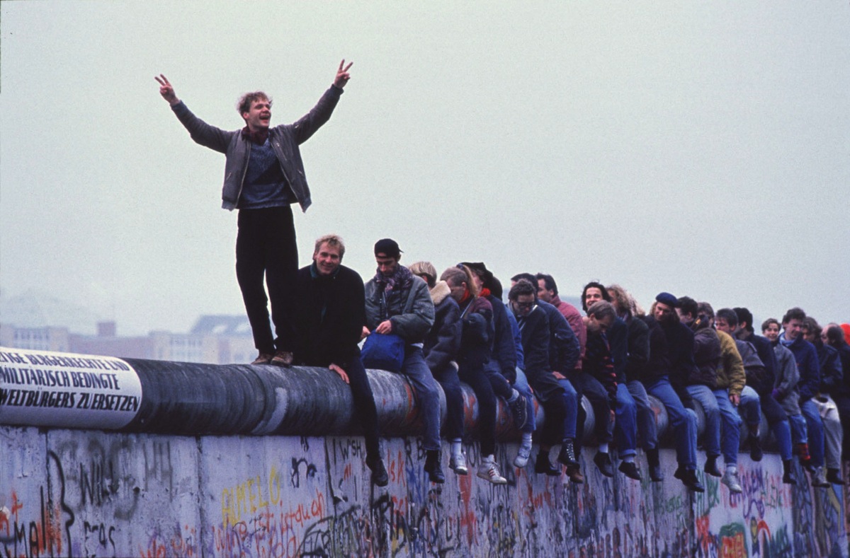 West Germans Celebrate The Unification Of Berlin Atop The Berlin Wall During The Collaps