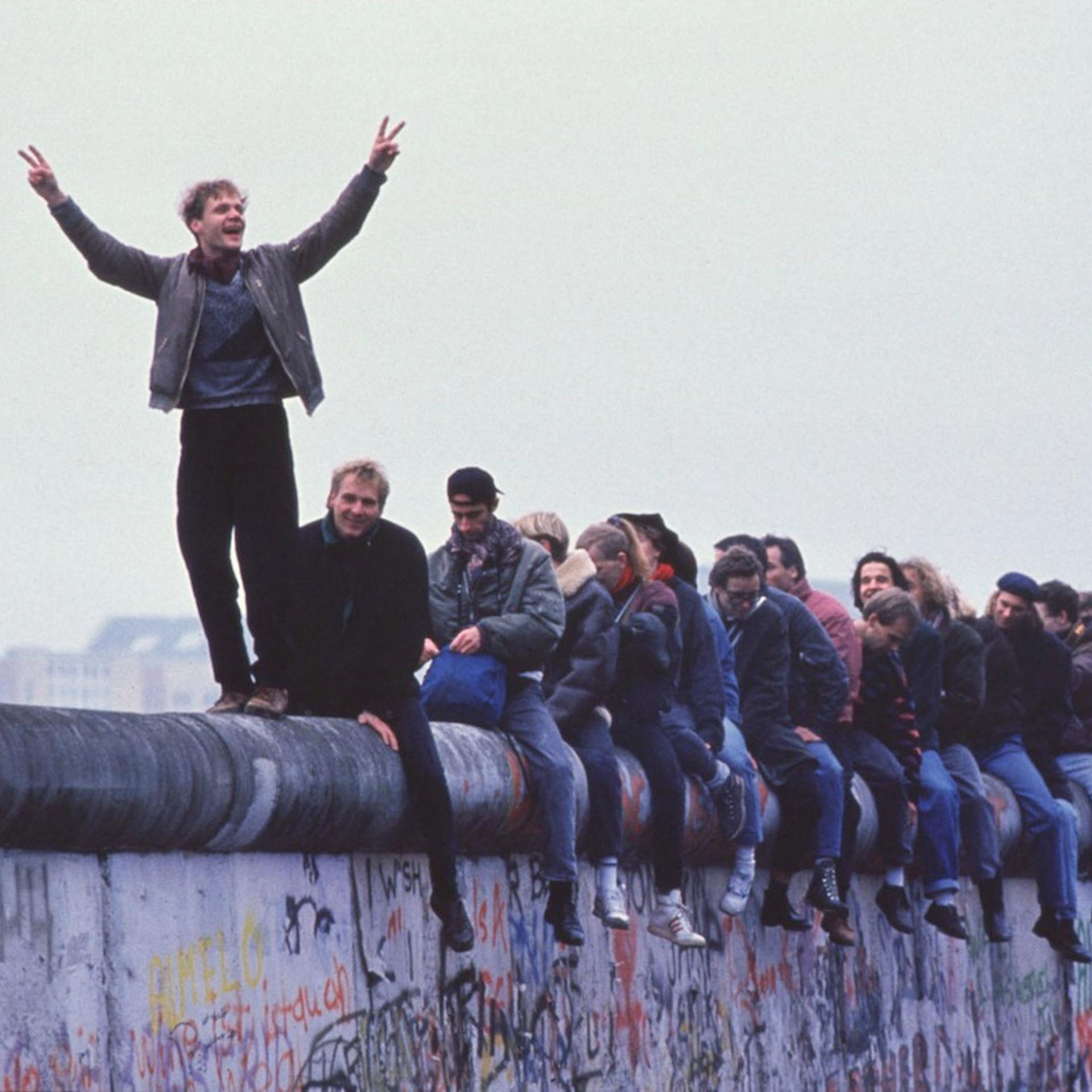 West Germans Celebrate The Unification Of Berlin Atop The Berlin Wall During The Collaps