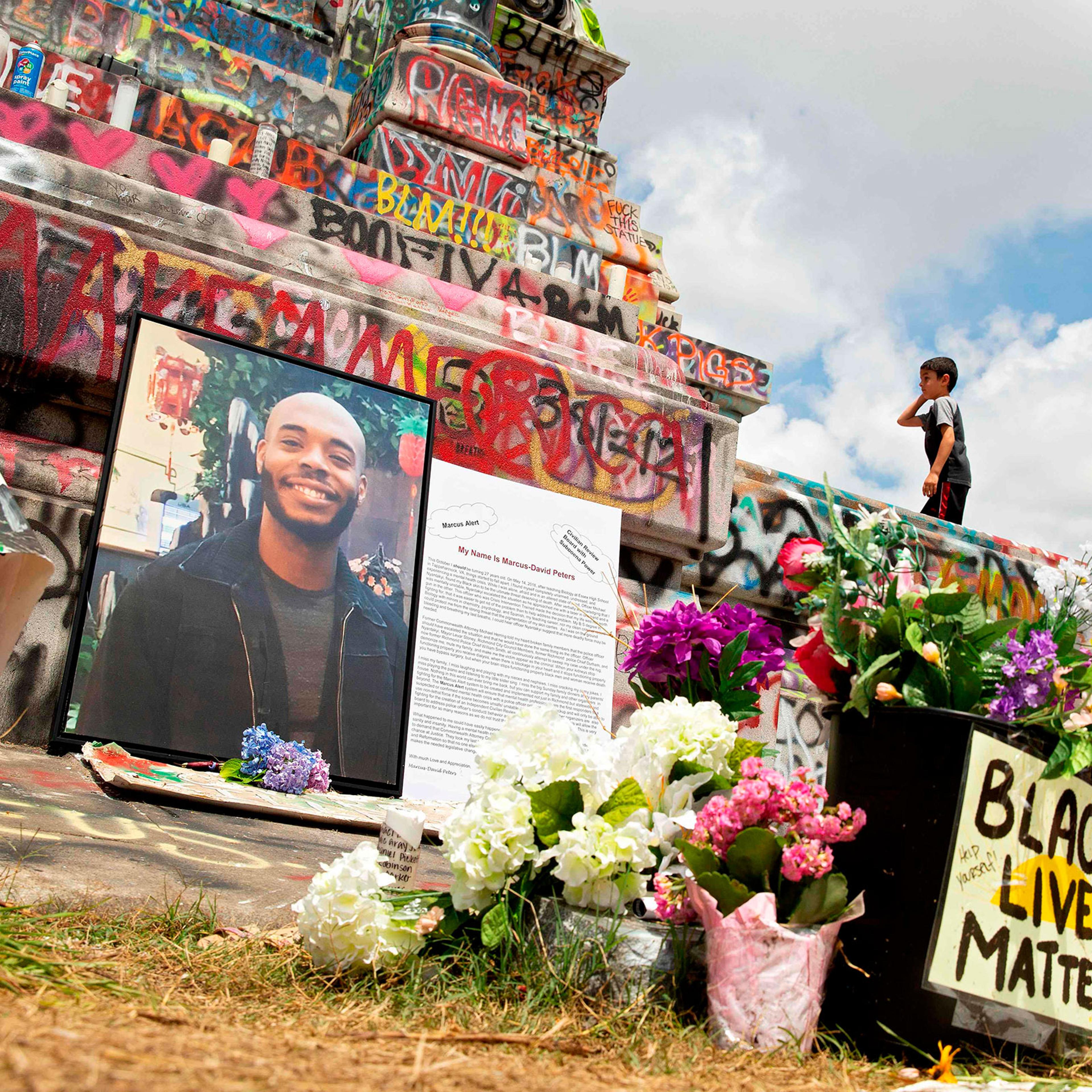 A memorial to Marcus-David Peters sits at the base of the Robert E. Lee statue on Monument Avenue in Richmond, Va.