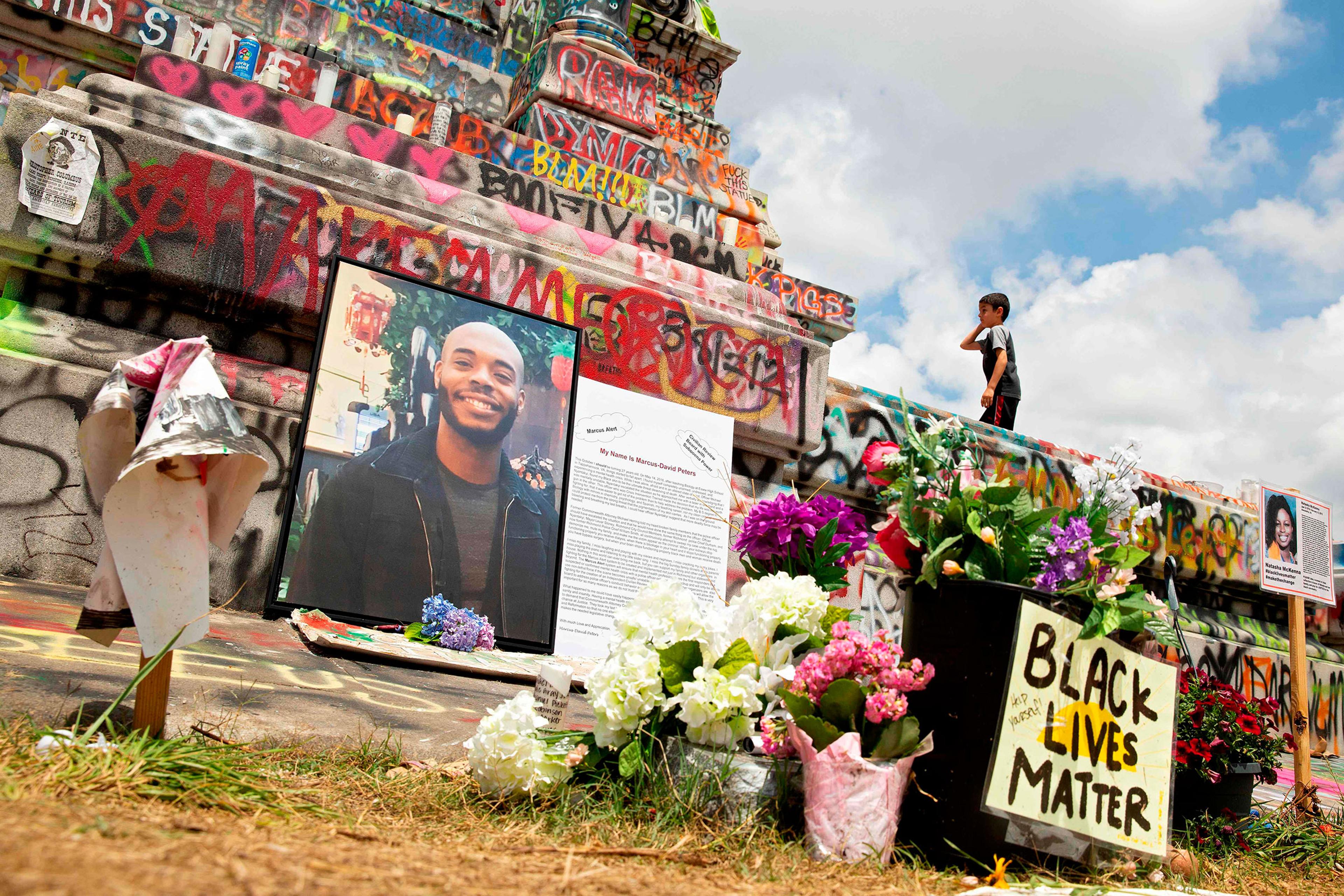 A memorial to Marcus-David Peters sits at the base of the Robert E. Lee statue on Monument Avenue in Richmond, Va.