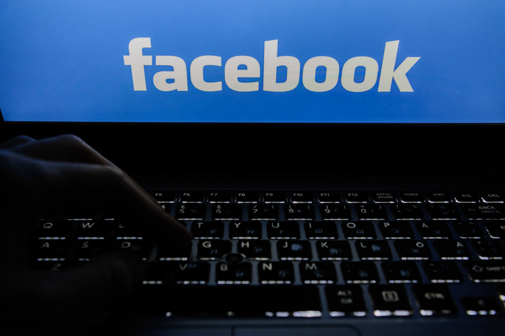 In this photo illustration, the Facebook logo seen on a