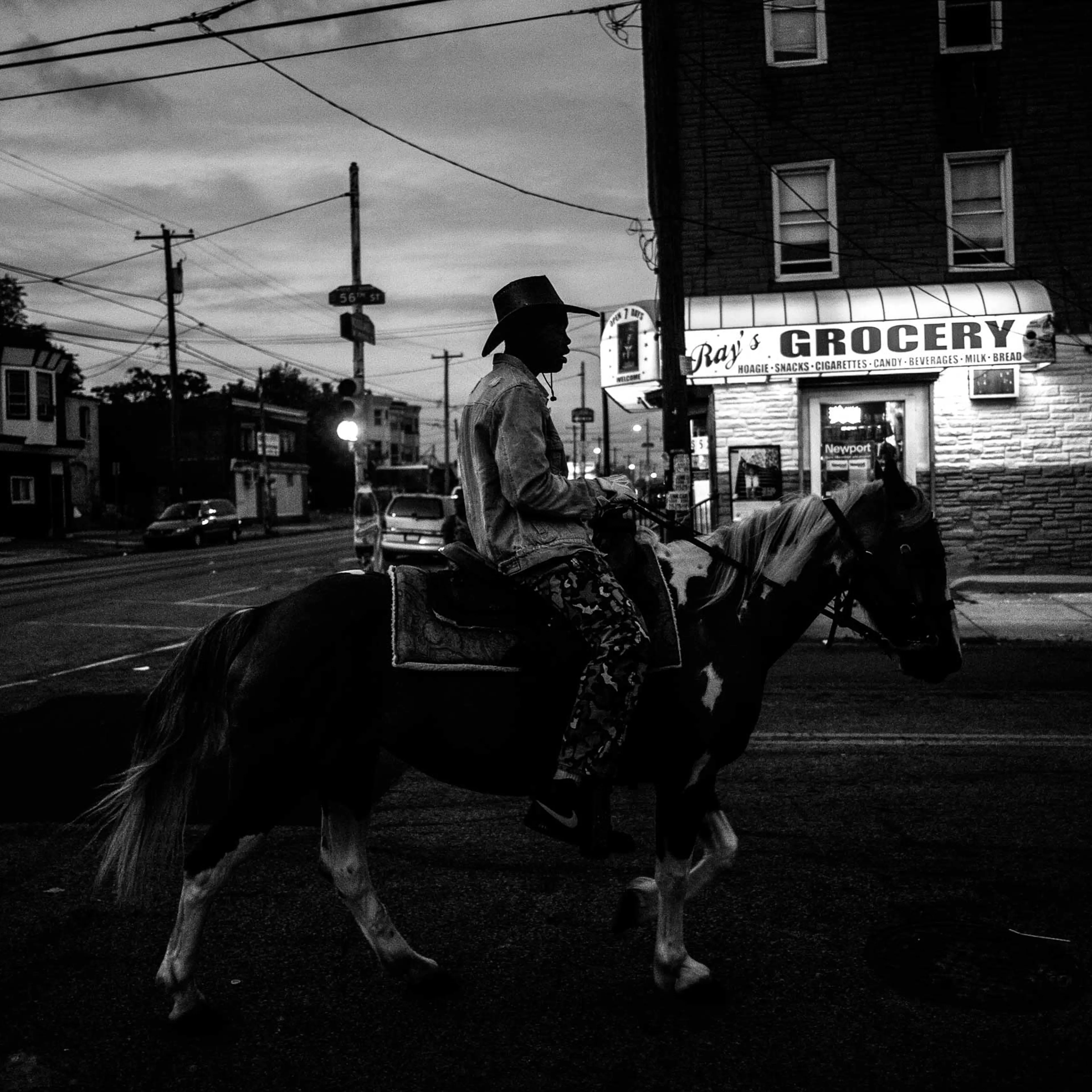 Shahir Drayton, 17, rides his horse back to the stables after a ride through the streets of southwest Philadelphia.