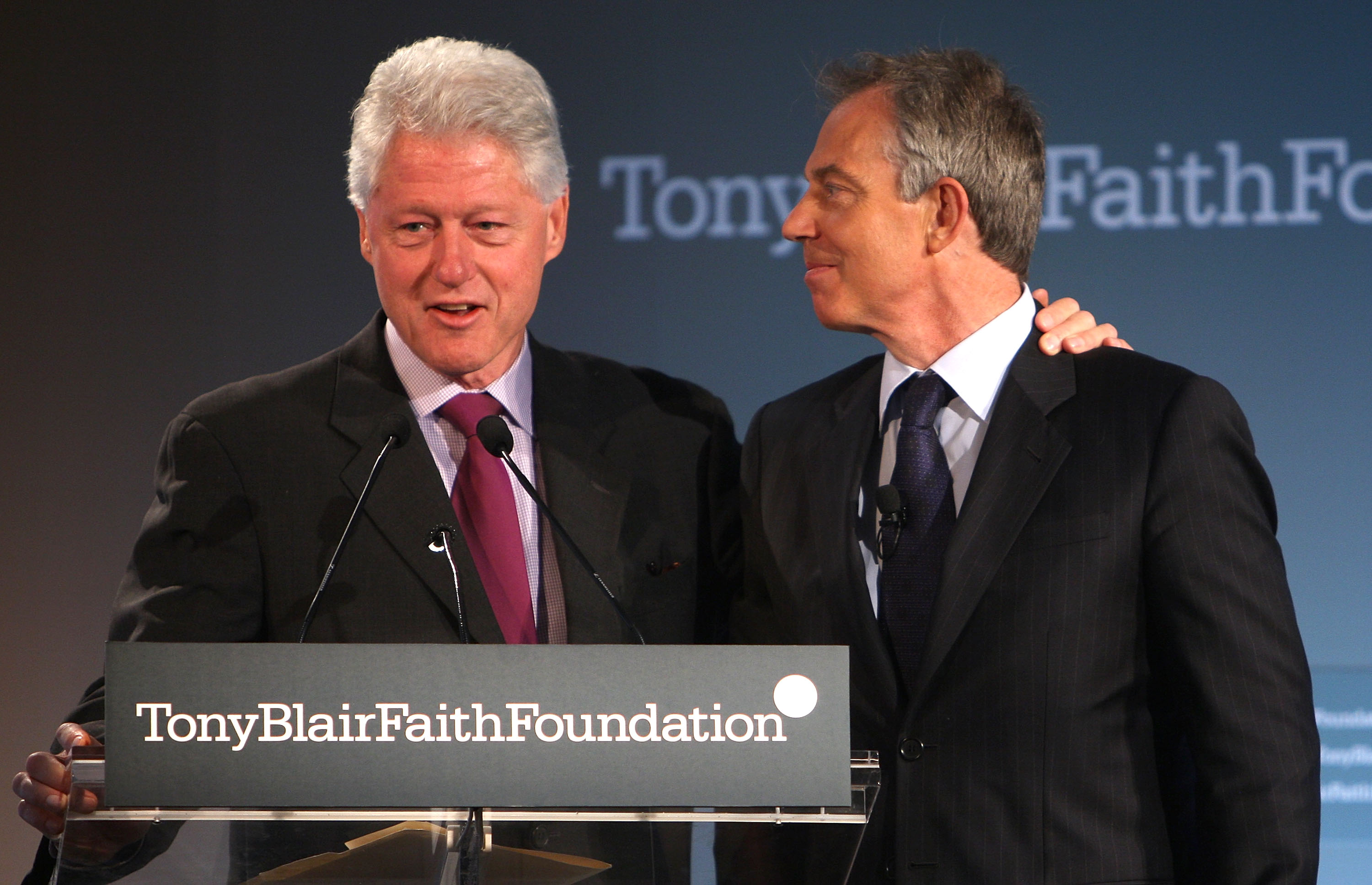 Former President Bill Clinton (L) addresses the audience while putting his arm around Former British Prime Minister Tony Blair during an event launching the Tony Blair Faith Foundation May 30, 2008 in New York.
