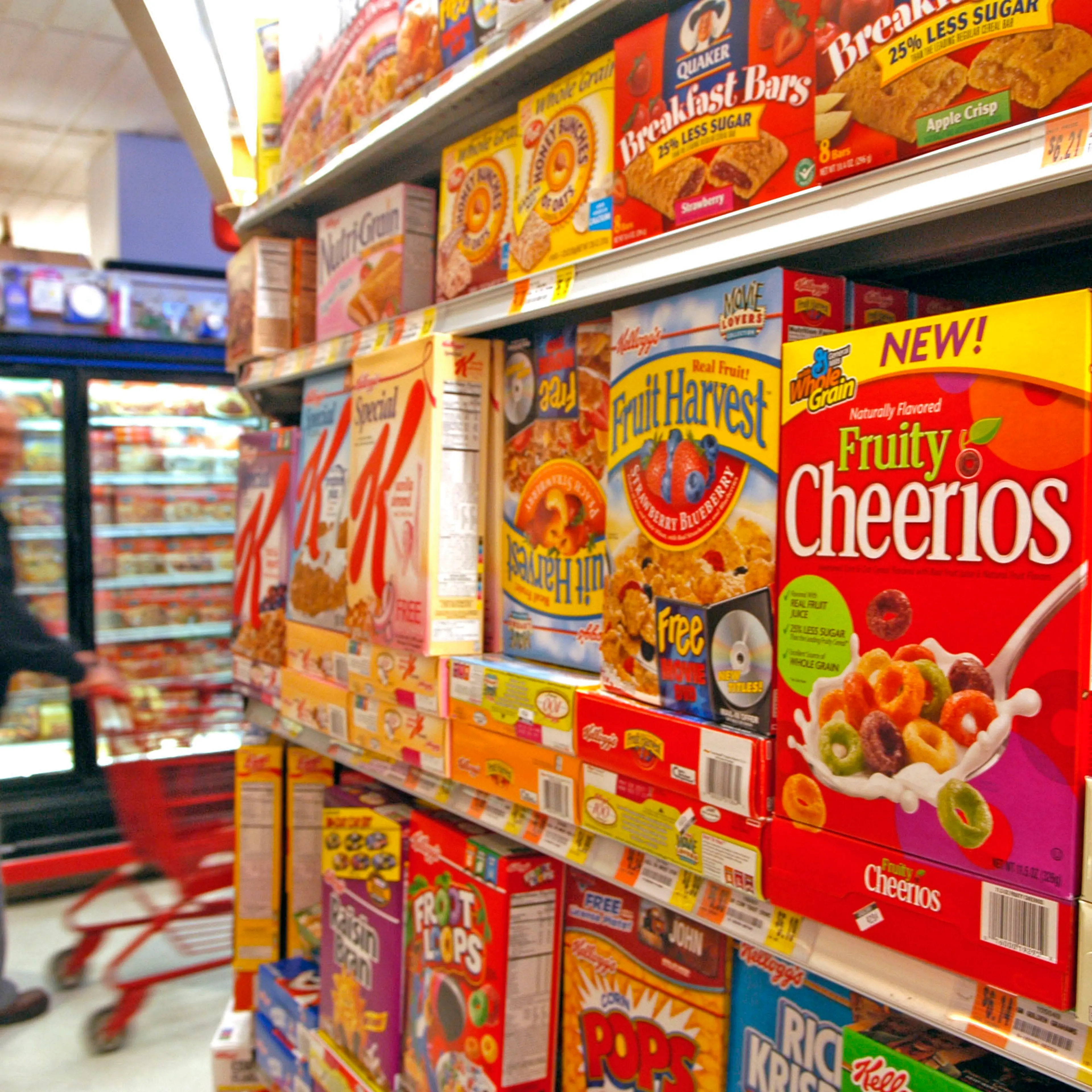 A man pushes his shopping cart past the cereal aisle where G