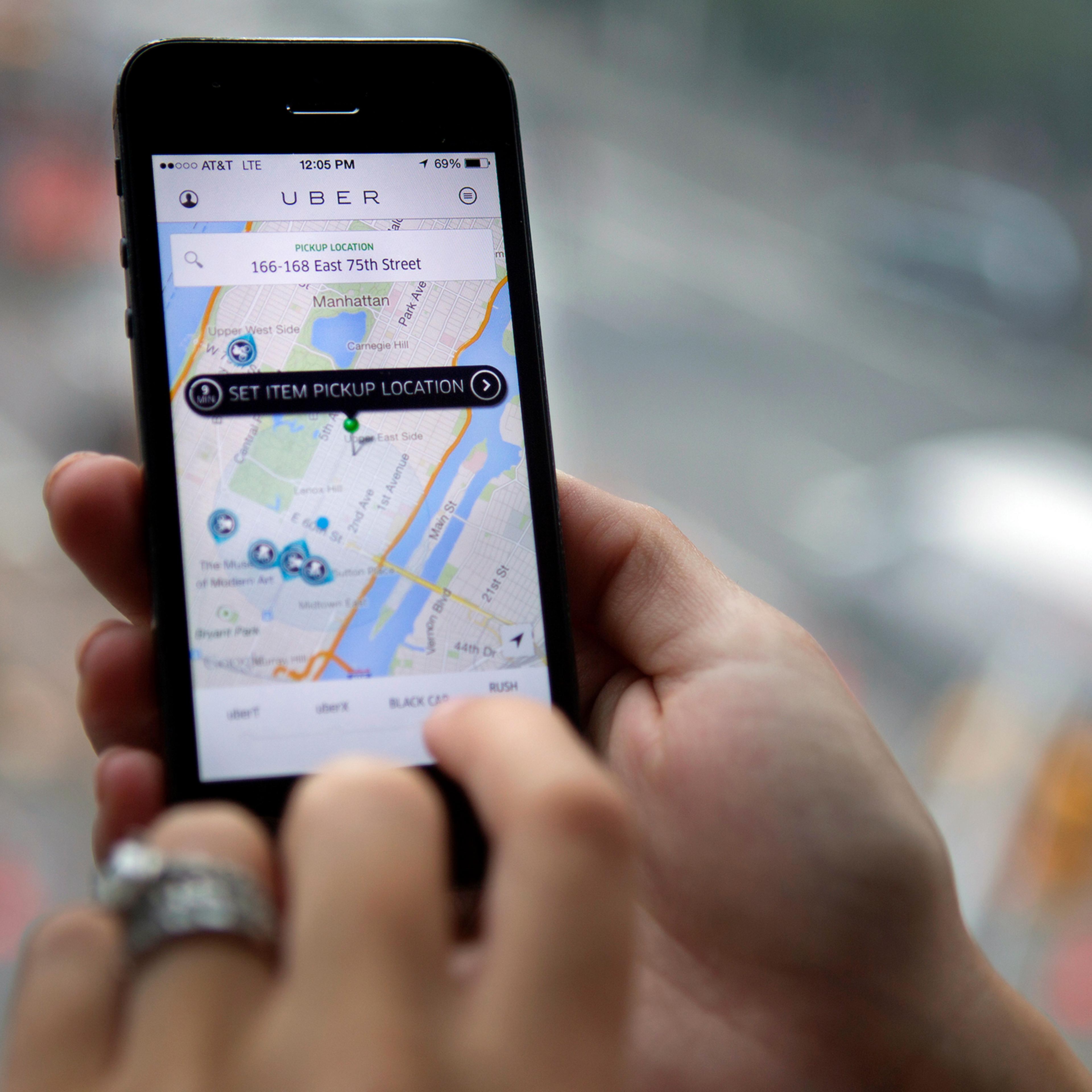 The Uber Technologies Inc. car service application (app) is demonstrated for a photograph on an Apple Inc. iPhone in New York, on Wednesday, Aug. 6, 2014.