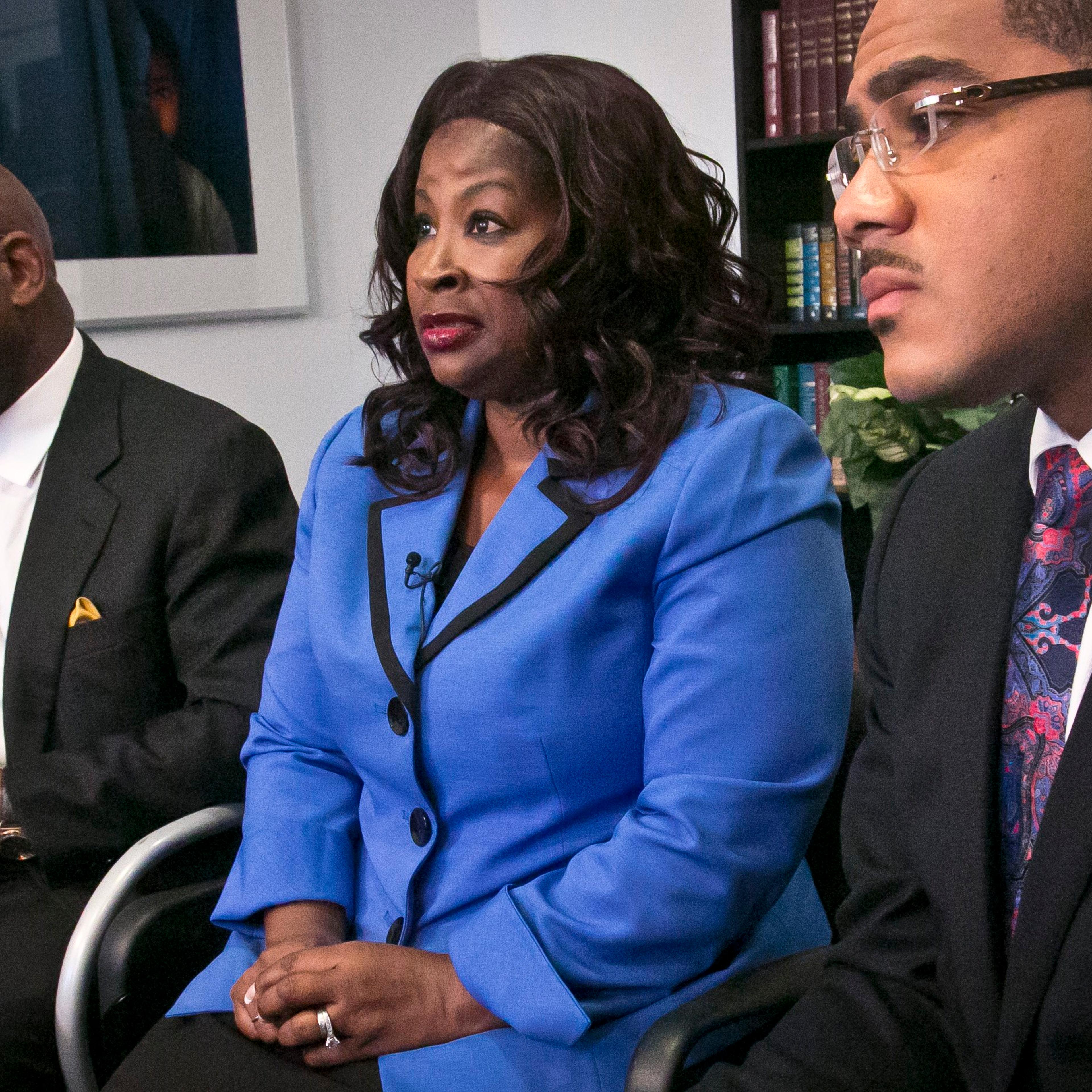 Cynthia Robinson with her attorneys Willie Gary (left) and Christopher Chestnut (right) as she speaks during an interview on July 21, 2014 in New York City.