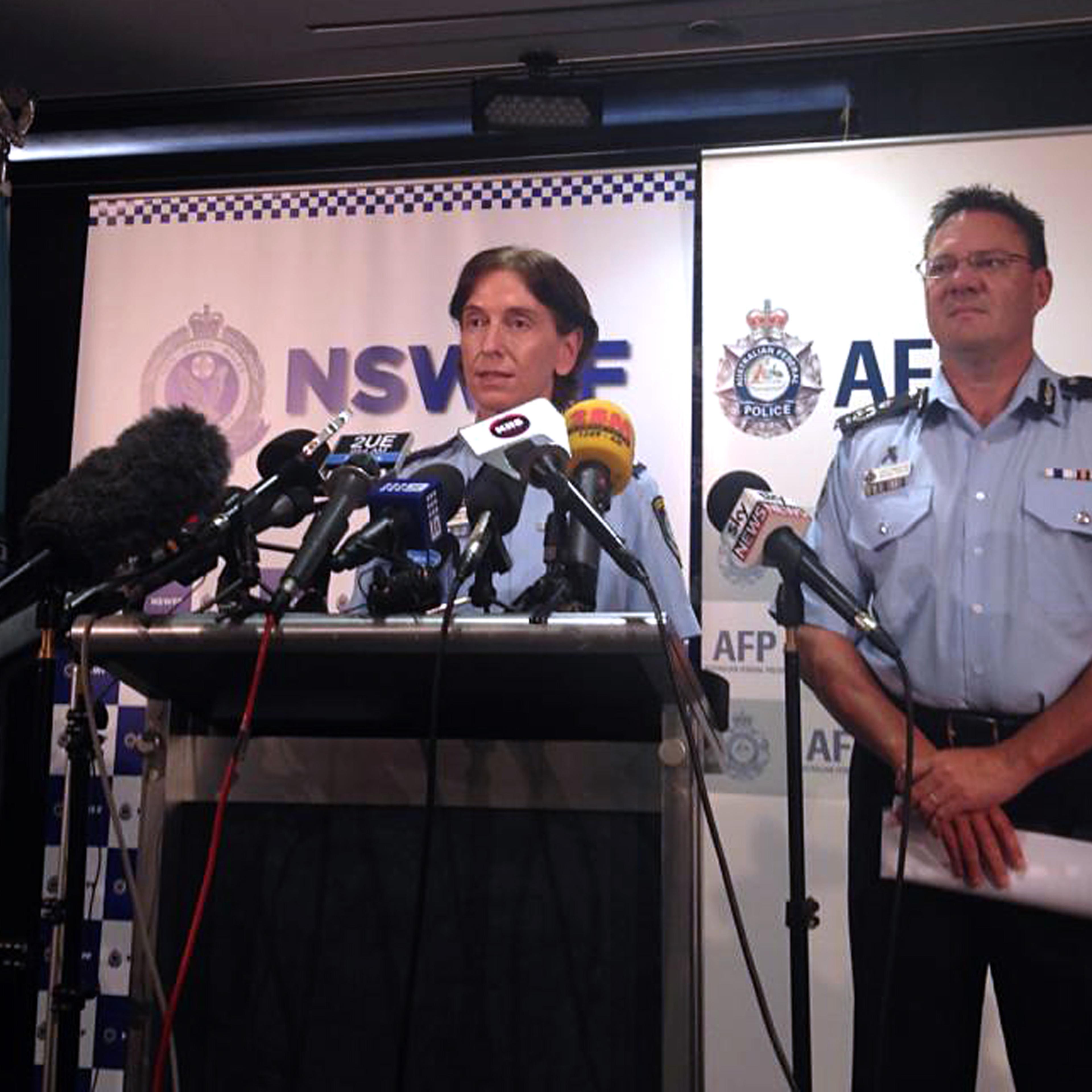 Australian Federal Police Deputy Commissioner Michael Phelan (R) listens as New South Wales Deputy Police Commissioner Catherine Burn speaks during a media conference in Sydney February 11, 2015