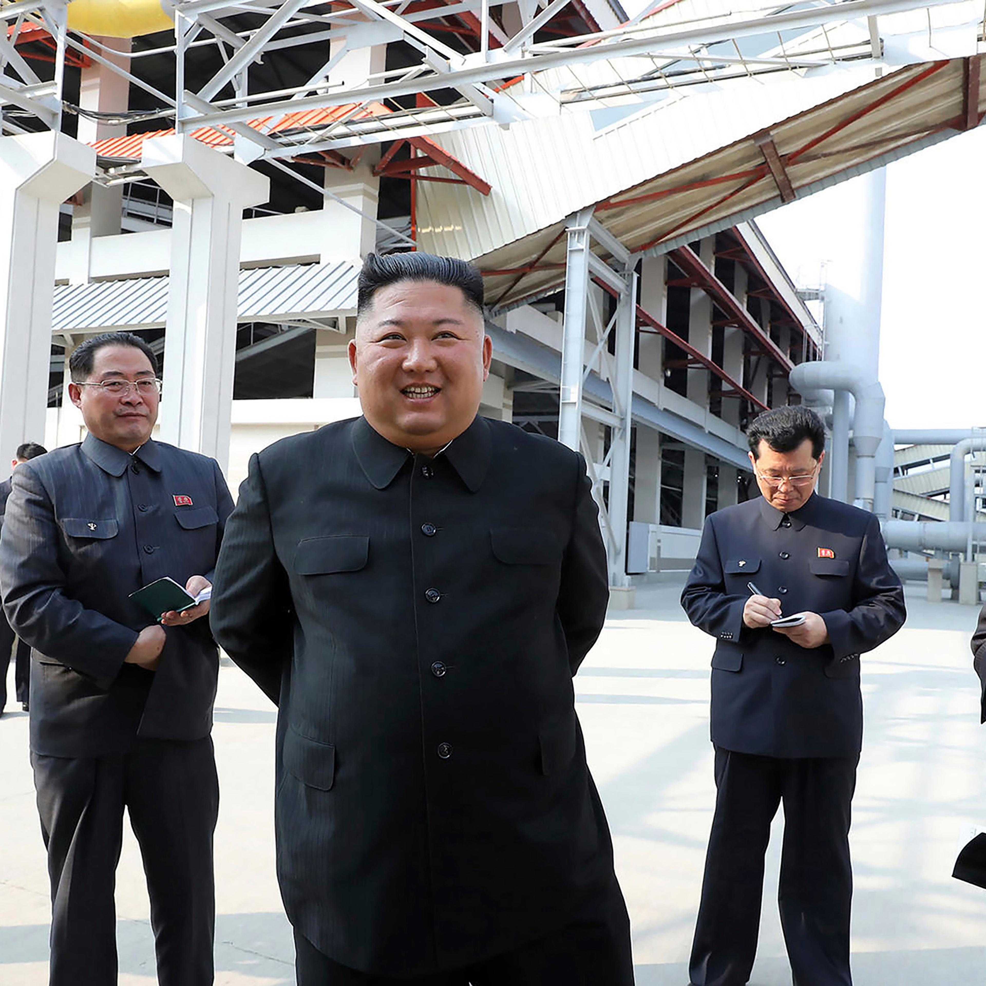 In this Friday, May 1 photo provided by the North Korean government, North Korean leader Kim Jong Un, center, visits a fertilizer factory in Sunchon, South Pyongan province, near Pyongyang.